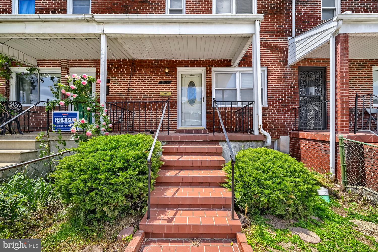 Welcome to this charming brick townhome in the heart of Greektown! Enter through the covered front porch into a warm and inviting interior featuring beautiful hardwood flooring throughout the main and upper levels. This 3-bedroom, 2-bath home offers a functional layout with all bedrooms conveniently located upstairs, each equipped with ceiling fans and serviced by a full bath with a tub/shower combo.

The fully finished basement provides additional living space and includes outside access, making it perfect for a recreation room, home office, or guest area. Step outside to enjoy the covered rear patio and fully fenced backyard ideal for relaxing, entertaining, or pets.

This home has great bones and is ready for its next owner to make it their own. Pride of ownership shines throughout the neighborhood, with well-maintained surrounding homes adding to the appeal. Conveniently located near local restaurants, shopping, parks, and commuter routes, Greektown offers easy access to downtown Baltimore, Canton, and major highways while maintaining a strong community feel.