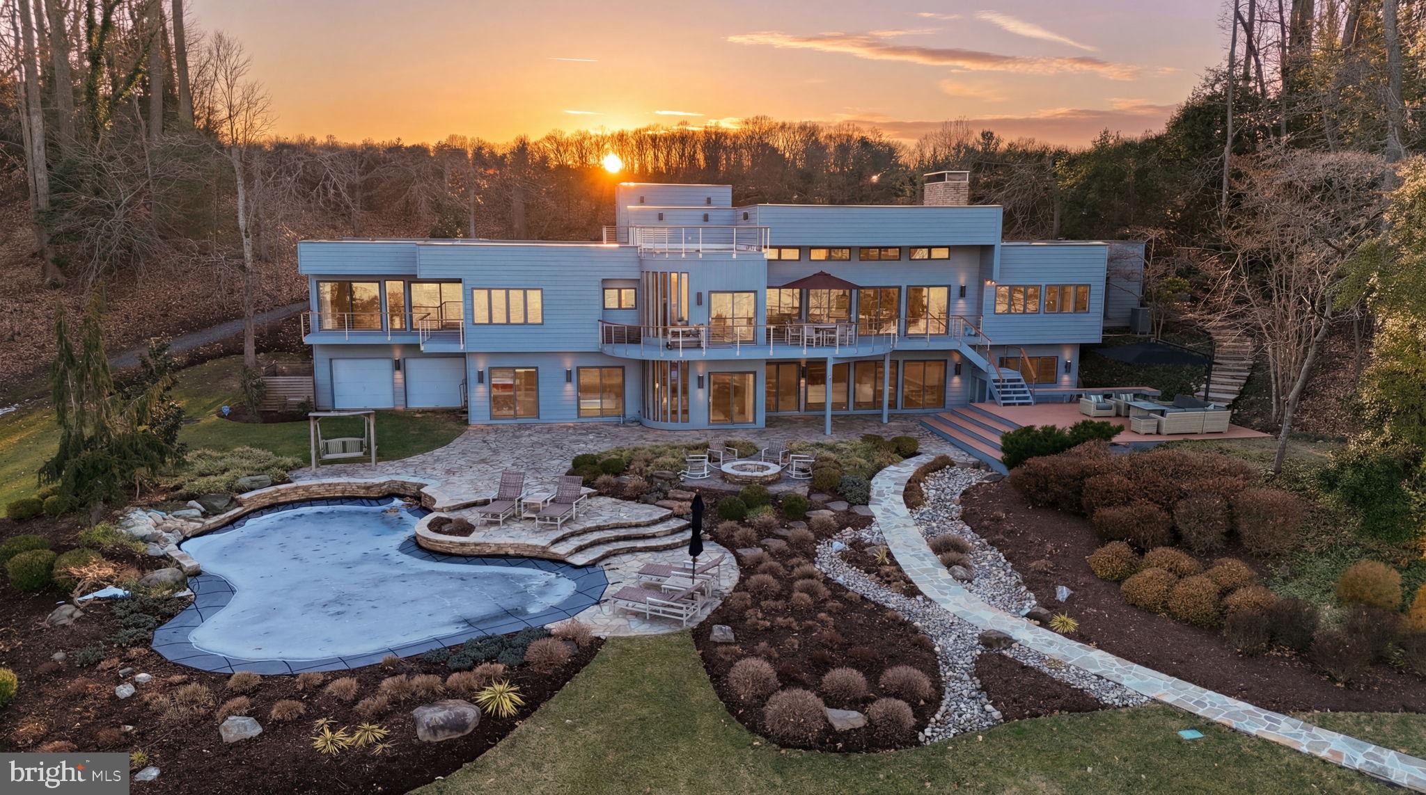 Welcome to the moment you fell in love with this stunningly renovated deep water waterfront oasis! Over 2.5 acres of peace, tranquility, and the most expansive views on the Severn River. The current owners have meticulously renovated the entire home, inside and out, over the last 10 years, and no detail was overlooked, nor expense spared. As soon as you walk in the door, you will be wide-eyed and breathless, and that feeling will not leave! Let's start with the dream kitchen featuring an enormous island, custom cabinetry, top-of-the-line appliances, and a wet bar with wine fridge.  When you take your eyes off the kitchen for a moment, you will begin to realize that this home was perfectly designed to enjoy the amazing views from every room, starting with the expansive family room with elevated ceilings and a soaring, stone, double-sided fireplace. On the other side of the fireplace is a room perfectly suited for whatever you desire, a game room, a reading room, a study, etc.  Also rarely available, this home features a main-level primary suite with an exquisitely remodeled waterfront spa-like bathroom. The lower level features another family room, exercise room, laundry room, and large storage area, along with 3 very generous waterfront bedrooms. Upstairs, you will find an expansive rooftop deck with an industrial-grade vinyl floor/roof... and amazing views!! The home is only the beginning!! The outside of the home is simply spectacular!! Anchored around the resort-style pool featuring a waterfall, PebbleTec finish, and travertine coping - good luck getting your guests to leave! Expansive deck with low-maintenance composite decking and mahogany cable railing handrails, fire pit, boulder walkways, curated rock beds, custom irrigation system, and Cast architectural landscape lighting all leading to your deep water (10 ft) pier with water, electric, and 10,000 lb boat lift. Yes, you have to see it to believe it, and please don't hesitate, as it is priced perfectly for a quick sale!