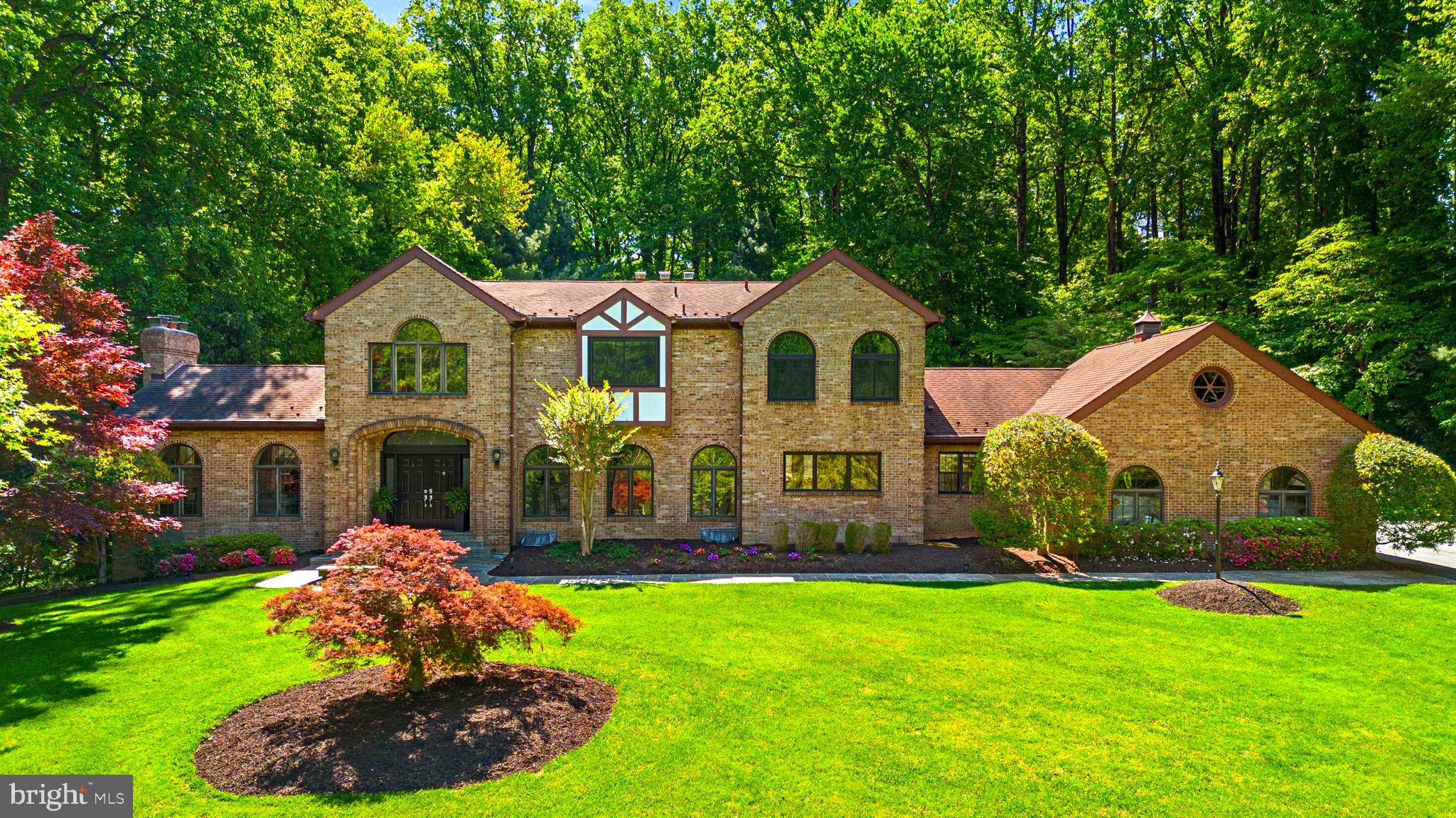 Nestled in the serene enclave of Bryants Grove this exquisite manor-style residence offers a luxurious lifestyle on a sprawling 3.06-acre lot. The exterior, crafted from elegant brick, exudes timeless charm, while the lush landscaping and mature trees create a private, secluded retreat. Step inside to discover a meticulously designed interior that seamlessly blends comfort and sophistication. The gourmet kitchen, featuring upgraded countertops and a spacious island, is a culinary enthusiast's dream. Enjoy meals in the inviting breakfast area or entertain in the grand dining space adorned with crown moldings and chair railings. The home boasts five generously sized bedrooms and five and a half bathrooms, including a lavish primary suite with an opulent bath. Rich hardwood complemented by a stunning curved staircase and built-ins that enhance the home's character,  the main level is an entertaining delight.Cozy up by one of the four fireplaces, each with elegant glass doors and mantels, creating a warm ambiance for gatherings. The finished walkout basement offers additional living space with a large bedroom ,fireplace, wet bar,and a private side exit. This would lend itself to inter generational living! Outside, a personal pool invites relaxation, and a charming gazebo provides a perfect spot for outdoor entertaining. With scenic vistas of the garden and woods, this property is a true sanctuary, offering an exclusive lifestyle that balances luxury with the tranquility of nature. Experience the perfect blend of elegance and comfort in this remarkable home.This home is a true delight and has been upgraded to provide a 21st century experience.close to shopping ,public transportation, and major roadways yet feels like a country retreat. Bryants Nursery is a rural rustic road which helps to preserve the natural environment and wildlife abounds..