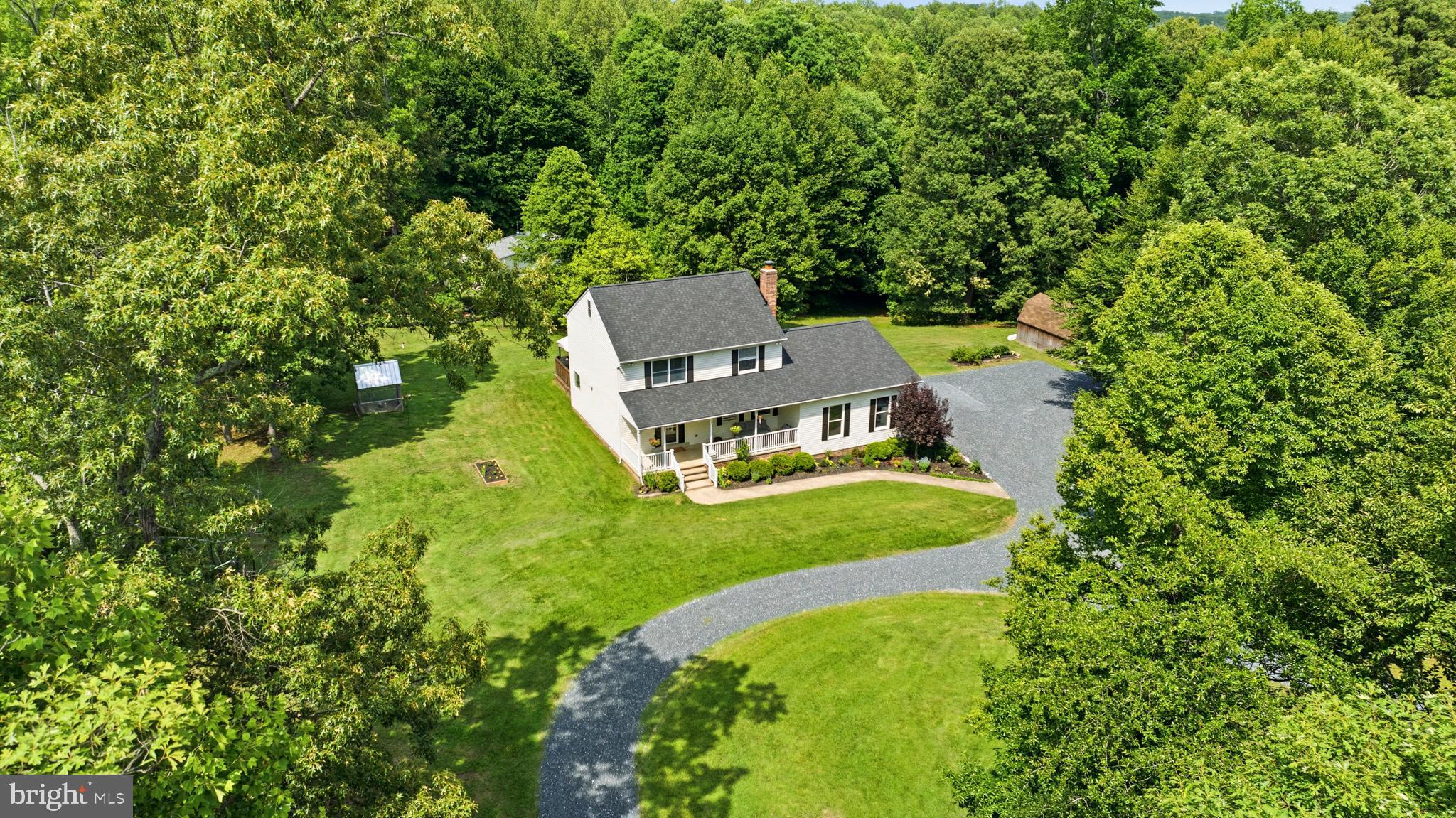 Nestled on 10 beautiful acres, this spacious home offers the perfect blend of comfort, functionality, and country living. Featuring 4 bedrooms  including a primary bedroom on the main level, this home provides a flexible floor plan to fit a variety of lifestyles. The kitchen is the heart of the main level, with updated counters, cabinets, appliances. Upstairs you'll find 3 decent size bedrooms, a full bath, a well thought out laundry room/half bath, and stairs to the attic for easier access. The slider off kitchen takes you to the back deck, overlooking a well-manicured backyard ideal for anything….gardening, animals, gatherings, and so much more! Enjoy evenings relaxing on the front porch, or the back deck, soaking in the outdoors around you. Outdoor enthusiasts, hobby farmers, and those in need of storage will appreciate the barn with overhang & loft/storage, large shed, and attached 2-car garage. With plenty of open space, the future possibilities are endless. This property offers the privacy and freedom you've been searching for while still being convenient to everyday amenities. Roof replaced June 2026.