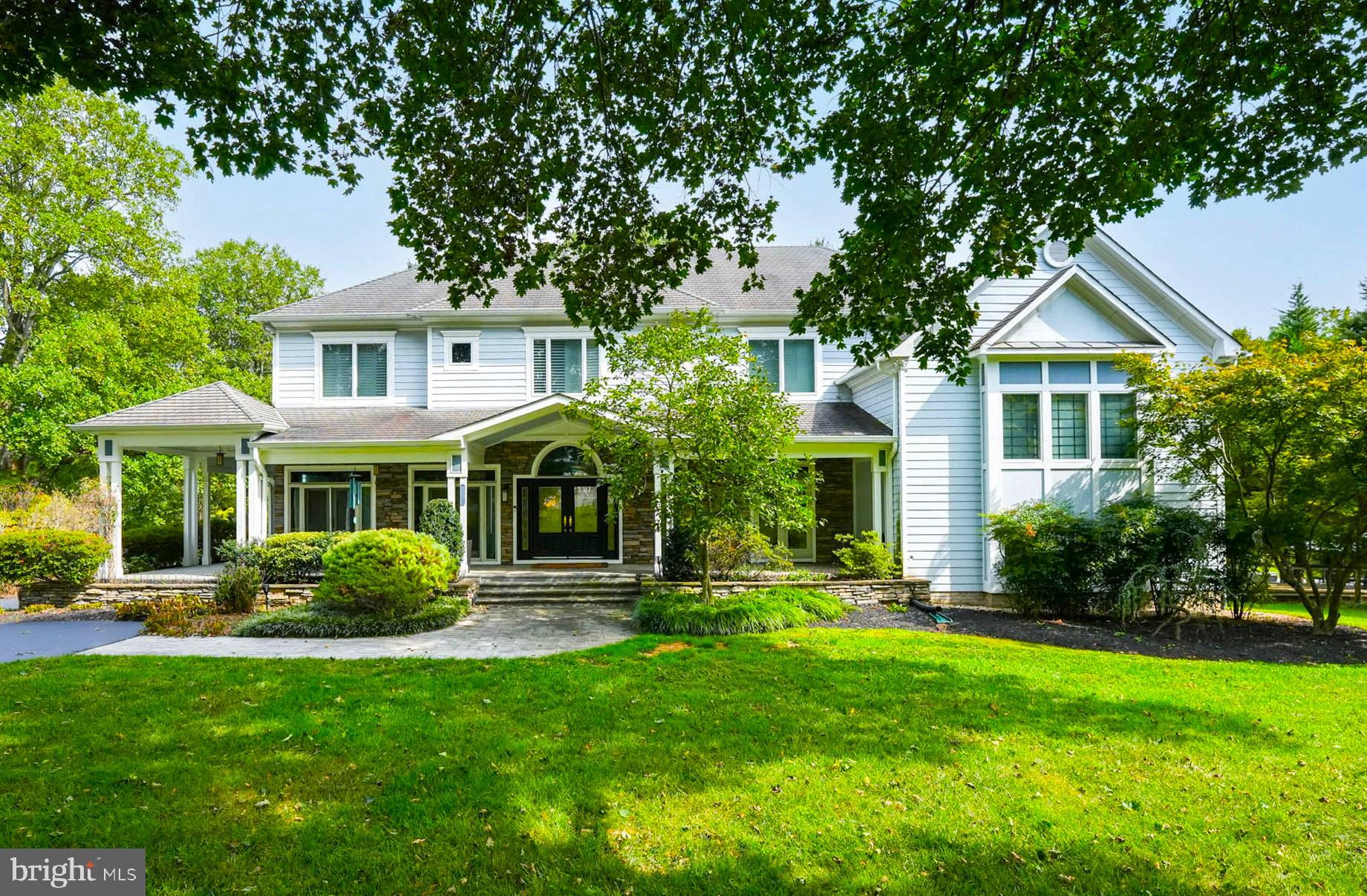 Situated on a large 0.95 acre lot just outside the Beltway in Mantua, this luxury custom home was built by a builder for his own family in the year 2000.  Approximately 6,300 finished square feet. 6/7 Bedrooms, 5 Full Baths, 3 Car side loading Garage.  The wrap around front porch and handsome front door welcome you as you enter the home.  Natural light fills the home from the multiple glass doors on the main level and large picture windows in family room.  Open floor plan and AMAZING eat in Kitchen recently remodeled with expansive Quartz island and countertop. Wolf Range, Subzero Frig, 2  Dishwashers.   2 story family room with stacked stone fireplace is open to kitchen area. Laundry room / mud room on main level off garage.  Banquet size dining room.  Main floor office  (could also serve as an additional bedroom with it's adjacent full bath). Take a few steps down to large walk out rec room.   Exquisite primary suite with walk in closet, fireplace and large bathroom with separate shower and tub.  Balcony off bedroom overlooks back yard.  3/4 additional bedrooms and 2 Jack and Jill full baths on this level plus a reading/loft area  nook overlooking family room.  Upper level rooms are all fitted with custom wood shutters.  (Currently 2 bedrooms on upper level have been made into one huge room but could create a 7th extra bedroom in this space).  Lowest level rec room/game room and exercise area were finished in last 2 years.  Separate in-law/au pair suite and kitchenette, living area, with exterior entrance on lower level.  Additional room: artist's studio.   Lots of storage space and closets as well as in attic over garage. Peaceful setting, beautiful private yard. A shed and vegetable garden area are on the side of the lot.  2 zones of HVAC - one replaced 2023, and the other in approx. 2019.  Woodson HS.
