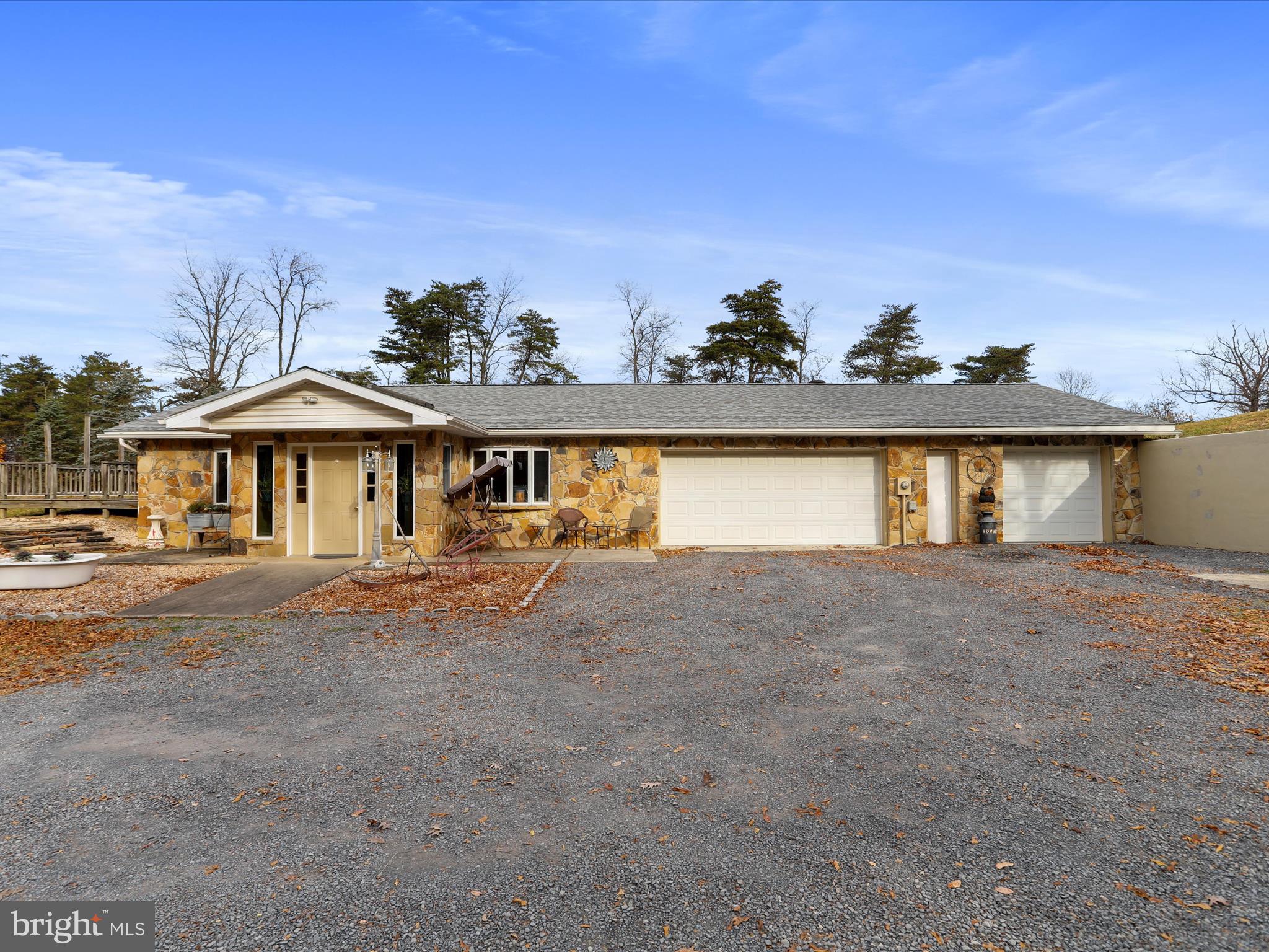 This all one level home features 4 bedrooms, 2 full bathrooms, 2 living spaces, kitchen, dining area, laundry and a 3 car attached garage. But that's not all, it has gorgeous views, 2 minutes from Fort Ashby's stores/restaurants, but you feel like you are in the middle of nowhere! 1.56 acres on a dead end street that offers privacy & peacefulness! There is also an inground heated pool. The forced air, hot water and pool are all heated by the outdoor woodstove! So efficient!