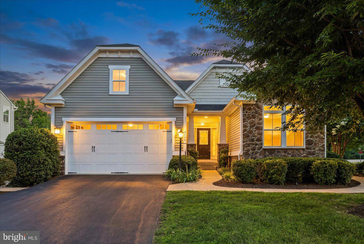 Original builder model offering a spacious, thoughtfully designed floor plan in excellent condition. This beautiful home features a brand-new HVAC system, a desirable main-level primary bedroom, and an inviting family room just off the kitchen with a stunning stone gas fireplace.

The finished lower level offers exceptional flexibility with a kitchen featuring a cooktop, refrigerator, and dishwasher, a full bath, an additional washer and dryer, and a large storage area with a Culligan water filtration system. New carpeting has been installed throughout the lower level and on the staircase.

Enjoy beautifully landscaped grounds, a fenced rear yard with a separate fenced area designated for the lower level, providing added privacy and versatility. Stainless steel kitchen appliances convey.  (Note the primary bathroom photo is missing and will be uploaded as soon as we receive it)