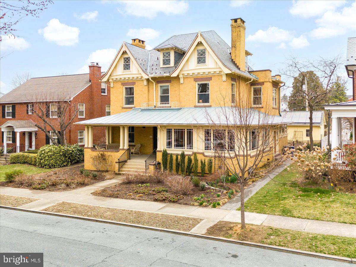 Step into a piece of history with this stately brick 1913 home that seamlessly blends classic architectural details and contemporary updates. The home has been lovingly cared for and modernized, while honoring its original features and design.  Situated on one of the most sought-after streets in downtown Frederick, the conveniently located home offers easy access to Baker Park, a rich showcase of downtown restaurants and shopping, walking distance to schools, and much more.

The hand-crafted pollinator garden, rich in color and texture year round, and a spacious covered front porch give you the first taste of this timeless treasure. Upon entering, you are welcomed into an elegant foyer showcasing gorgeous hardwood floors, rich wood trim, and original pocket doors.  The lofty 10-foot ceilings and large windows of the first floor allow for natural light to highlight charming period details and ornate stained glass.  A grand staircase in the center of the house captures the home’s original character.

Entertaining is made easy here with the thoughtfully updated kitchen. It features an inviting center island finished with marble countertops, ample cabinet space, and modern appliances—perfect for both casual meals and culinary endeavors.  Gather with family and friends in the elegant formal dining room, surrounded with oak wainscoting and unique built-in cabinetry, or more casually in the backyard, outfitted with a generous deck and custom hardscape, and wrapped by more gardens and a hand-crafted pond. The two-car detached garage, adorned with fully owned solar panels, provides convenient parking as well as additional privacy.

Upstairs, the warmth of hardwood floors continues on the second and the third levels, and the generous layout provides flexibility for bedrooms, home offices, or hobby spaces. Newly updated bathrooms allow for spacious, modern convenience, while giving a nod to the design work of the early 20th century. 

This home offers the perfect balance of historic charm and contemporary living. Don’t miss the opportunity to own a truly unique property—one that stands out with its timeless craftsmanship, comfortable flow, and convenient location.