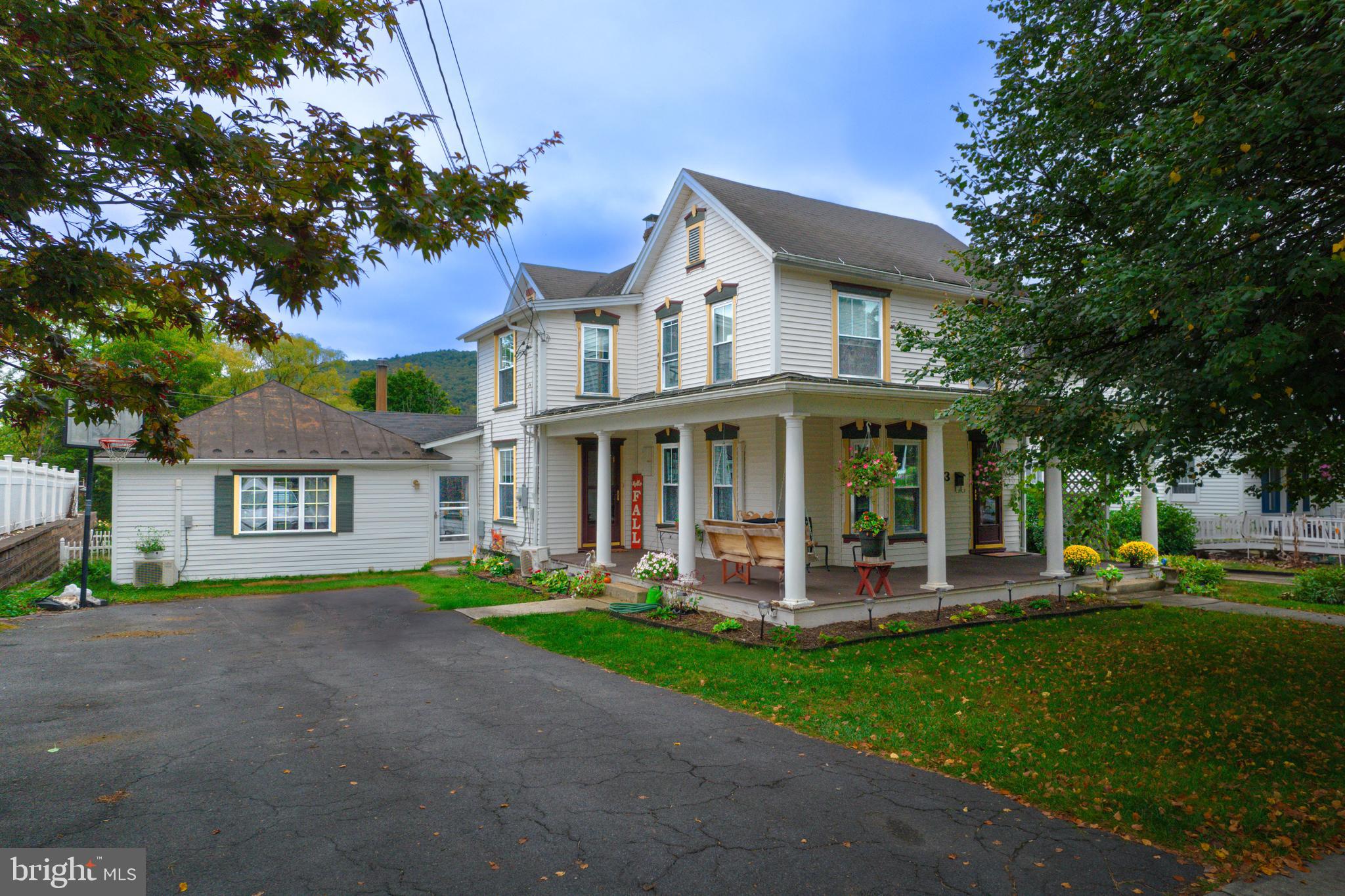 Get ready to FALL in love with 433 S Juliana Street! Discover the charm of this expansive residence nestled in the heart of Bedford Boro. It boasts a sizable recreation room adjacent to the kitchen, complete with a cozy wood stove. The kitchen offers ample storage and a pantry, along with plenty of counter space for meal preparation. Enjoy the convenience of a first-floor master bedroom with an en suite bath, and a laundry room also on the main level. The elegant dining room and living room feature hardwood floors that lead to a wrap-around porch. Half bath off living area. Upstairs, four bedrooms await, alongside an extra sitting area with a coffee bar. There's also a full bath on this floor. Outside, relish the screened porch that opens to a deck, and a flat, fenced-in yard. Just few blocks from downtown Bedford and walking distance to Bedford Middle and High School. Welcome Home!