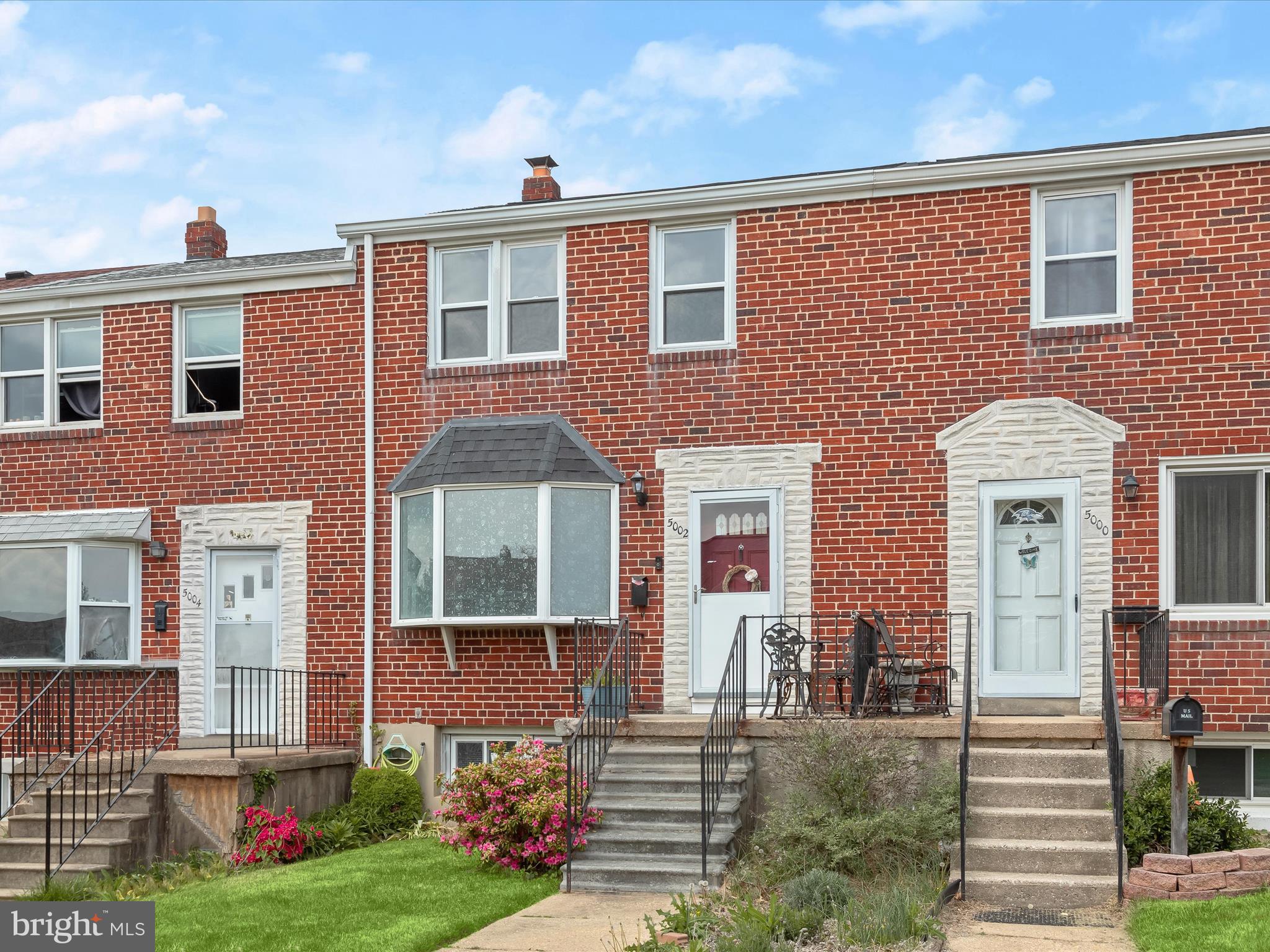 Welcome to this charming brick exterior rowhome in Baltimore's Maiden Choice Village community! A welcoming front porch invites you into a bright, open living room featuring a bay window, neutral tones, and beautiful hardwood floors flowing seamlessly throughout the main level. The dining room offers classic chair railing and connects effortlessly to the kitchen with a breakfast bar, perfect for casual dining. The updated kitchen is a dream with 42” cabinetry, granite countertops, stainless steel appliances, a stylish backsplash, and access to the rear patio and fenced backyard. Upstairs, discover three generously sized bedrooms with closet organizers and a full hall bath. The fully finished lower level adds valuable living space with luxury vinyl plank flooring, a full bath, ample storage, and walk-out access to landscaped grounds and a parking pad. Conveniently located near major commuter routes, including I-95, I-83, and I-695, this home has it all! Updates:   New roof installed in 2021. New water heater 2020. The seller is supplying a 1-year warranty to the buyer. Covers HVAC  as well. HVAC Furnace and AC were replaced in 2021