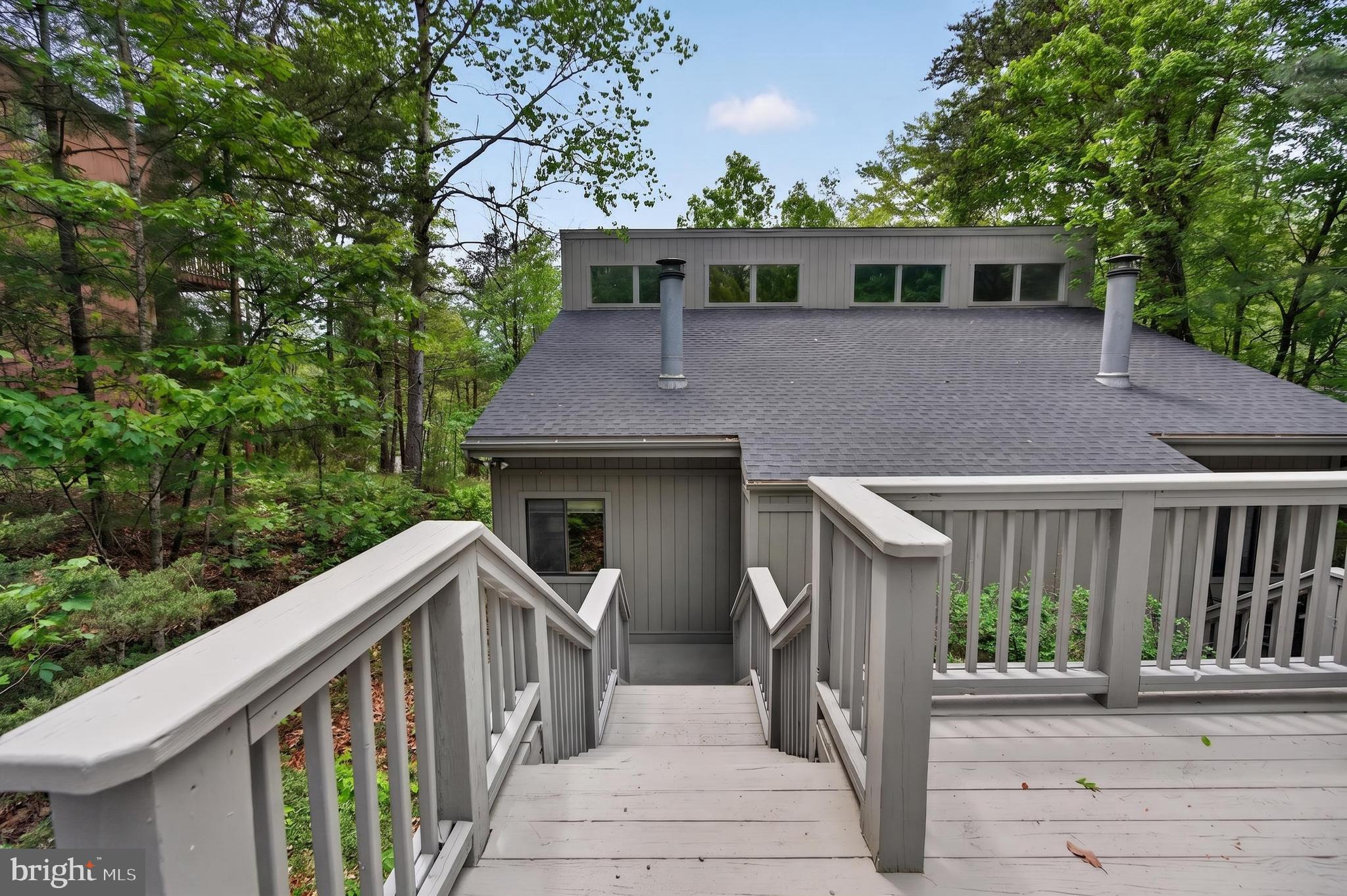 Discover the perfect blend of comfort and modern living in the beautifully updated 2 Bedroom, 2 Bath duplex, ideally situated just outside of Bryce Resort where there are an abundance of outdoor activities nearby including golf, skiing, mountain biking and hiking in the National Forest.  Located just minutes from the stunning 45 acre Lake Laura, you can enjoy swimming, fishing, kayaking as well as relaxing on the grassy beach.
This  inviting unit is move-in ready, showcasing Cathedral ceilings, brand new wood floors in the Great Room, fresh interior paint and updated bathrooms.  When you step inside you are greeted  by a spacious, open layout featuring a Swedish Fireplace that adds to the inviting mountain charm of this home.  Enjoy seamless indoor-outdoor living with direct access  from the first floor bedroom to the lower patio, perfect for morning coffee or evening relaxation.  The private backyard, bordered by a privacy fence , offers a serene space to unwind.  
The upper level offers a large open loft-style bedroom with its own balcony that overlooks the tree canopy.  This bedroom also boasts a full bath featuring a jetted tub and a sauna!
Recent upgrades ensure your peace of mind, including a partial roof replacement on the backside, new windows and sliding glass doors and extensive exterior repairs that includes a new French Drain system. Also included are new floor joists, vapor barrier and insulation.
Conveniently, this charming home is an easy walk down the hill to the local community store, Pale Fire Brewery, Burn Barrel restaurant and Smiley's-where you can indulge in a sweet treat or let the kid in you enjoy putt-putt or gem mining.