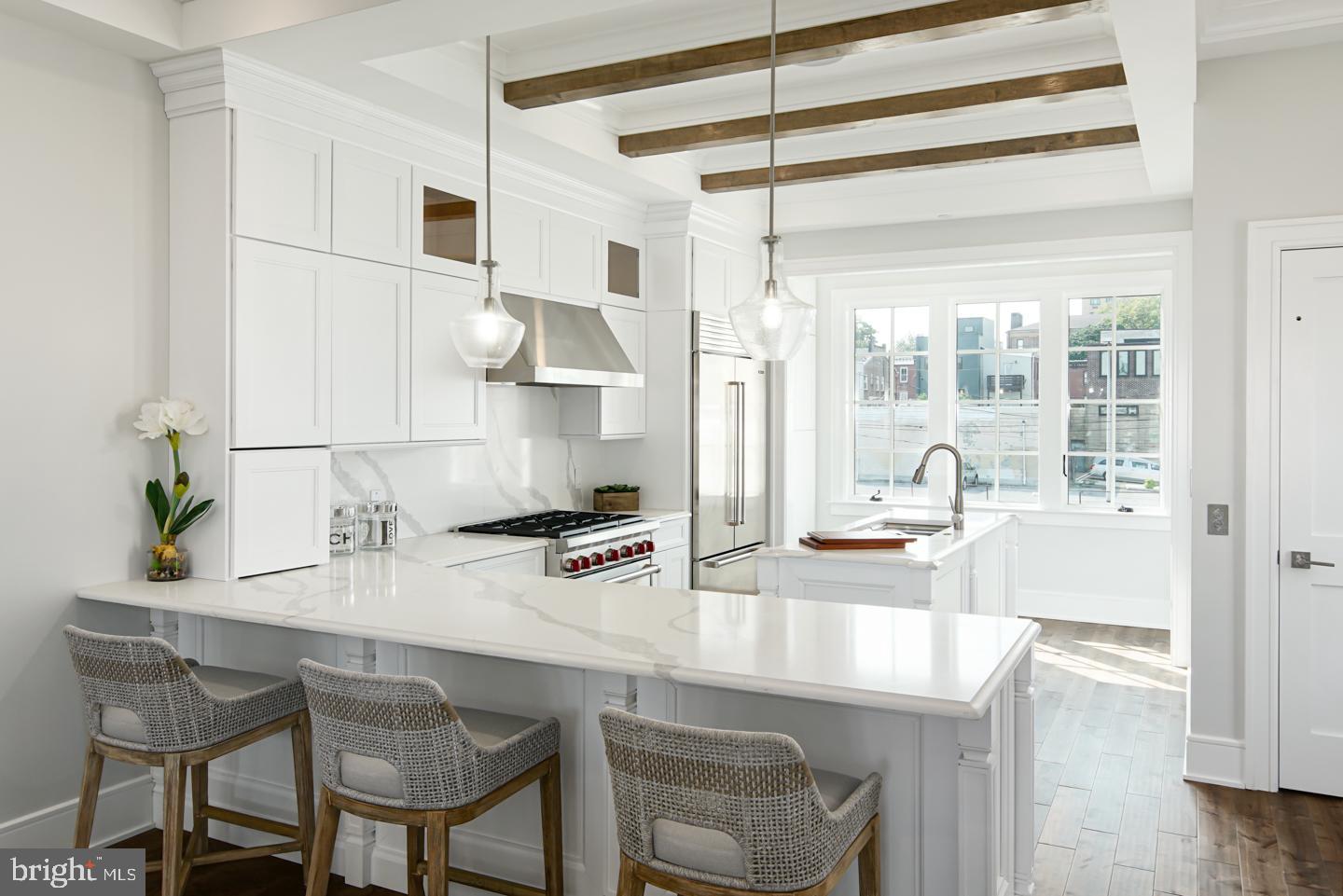 2- CAR PARKING OFFERED! Luxury Living at Lydian Place offers the quintessential city lifestyle. These ten exquisitely designed townhomes on the Avenue of the Arts create a unique urban experience to enjoy the rich cultural life of Center City Philadelphia. Renowned architectural firm Asher Slaunwhite created an eclectic mix of contemporary and classic themes throughout each home. With 4,000 square-foot of living space across 5 levels, each home features 3 spacious bedrooms, four full baths, and two powder rooms, with a masterfully designed pilothouse, two decks, and elevator access! Step up from the light-filled foyer and atrium to the expansive open concept main level framed by a bank of french door-style windows. Enjoy the comfortable living room with high ceilings, custom hardwood flooring throughout, balcony overlooking Broad street, and an ample dining area that flows into the gourmet chef kitchen. Luxurious yet functional, the kitchen features an oversized island, peninsula seating, custom quartz countertops, and backsplash, with appliances from Subzero, Asko, and Wolf. The third floor is comprised of two large bedrooms with en-suite bathrooms, walk-in closets, and a full-sized laundry room. The impressive owner's bedroom suite's regal 600 sq ft is the ultimate sanctuary and occupies the entirety of the fourth floor. The owner bath is wrapped in Calacatta marble style and features a freestanding soaking tub, an oversized shower room of seamless glass, a private lavatory, a double vanity, separate makeup vanity, and fixtures from the striking Kohler Margaux series. Special attention has been given to the rooftop with a masterfully designed layout highlighting a spacious 375 sq ft pilothouse complete with a custom wet bar and convenient powder room nestled between the two separate decks. This optimal space for entertaining offers spectacular panoramic views of the Philadelphia skyline. More home enjoyment comes with the fully finished lower-level family room or media room and includes a bedroom/office/exercise room and full bathroom. There's more: each home offers 1-car garage parking with tons of extra room for storage, a top-of-the-line security system with one year of free monitoring services, and a multi-zoned energy-efficient HVAC system. The audio system includes five pairs of in-ceiling speakers, one pair of outdoor speakers. A Sonos Connect system plays music throughout the entire home. Smart wiring infrastructure is installed for ultimate convenience and future upgrade possibilities with dual data (Cat6) and cable in every bedroom. Upgrade options include an outdoor kitchen and grill, decorative ceilings in the living/kitchen/dining area, a built-in fireplace in the living room, custom millwork, and additional smart-home technology. Walk Score - 97 Transit Score - 100 Bike Score - 88. Conveniently located near Target, Sprouts Market, Whole Foods, Pet Smart, & PA Wine & Spirit Shop. Some homes are currently being built. Taxes estimated, 10 YEAR TAX ABATEMENT, some finish choices may vary, and features are shown may be upgraded. Specifications, details, and finishes are subject to change.