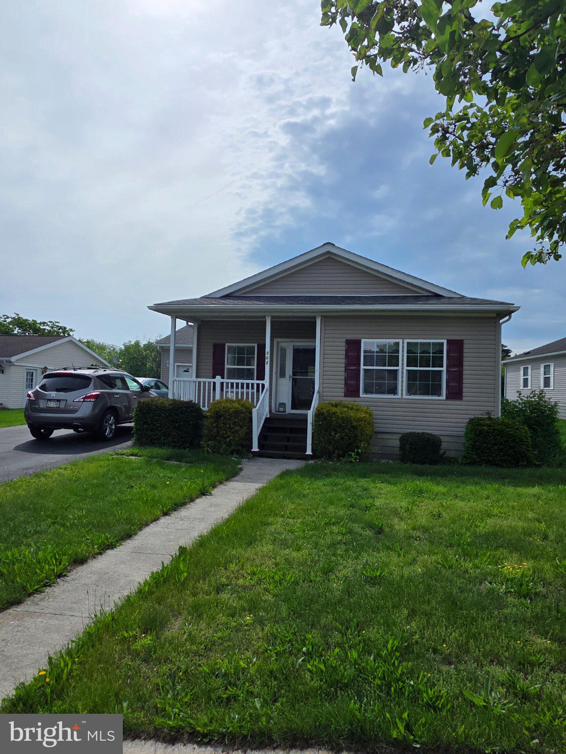 This delightful double-wide manufactured home, built in 2006, offers 1,352 sq. ft. of comfortable living space. Inside, enjoy a bright kitchen with an island, perfect for gatherings, alongside a cozy dining area and spacious living areas adorned with plush carpeting and hardwood flooring. Step outside to find a lovely deck, ideal for enjoying serene mountain views. The community boasts well-maintained sidewalks, streetlights, and a vibrant community fostering connections with neighbors. Conveniently located near parks and local amenities, residents benefit from easy access to recreational activities, a clubhouse with a full gym, library, games and TV all included with 24-hour access. With an attached oversized garage and included appliances like a refrigerator and dishwasher, this home combines comfort and practicality. Embrace a lifestyle of ease and community in this inviting space!