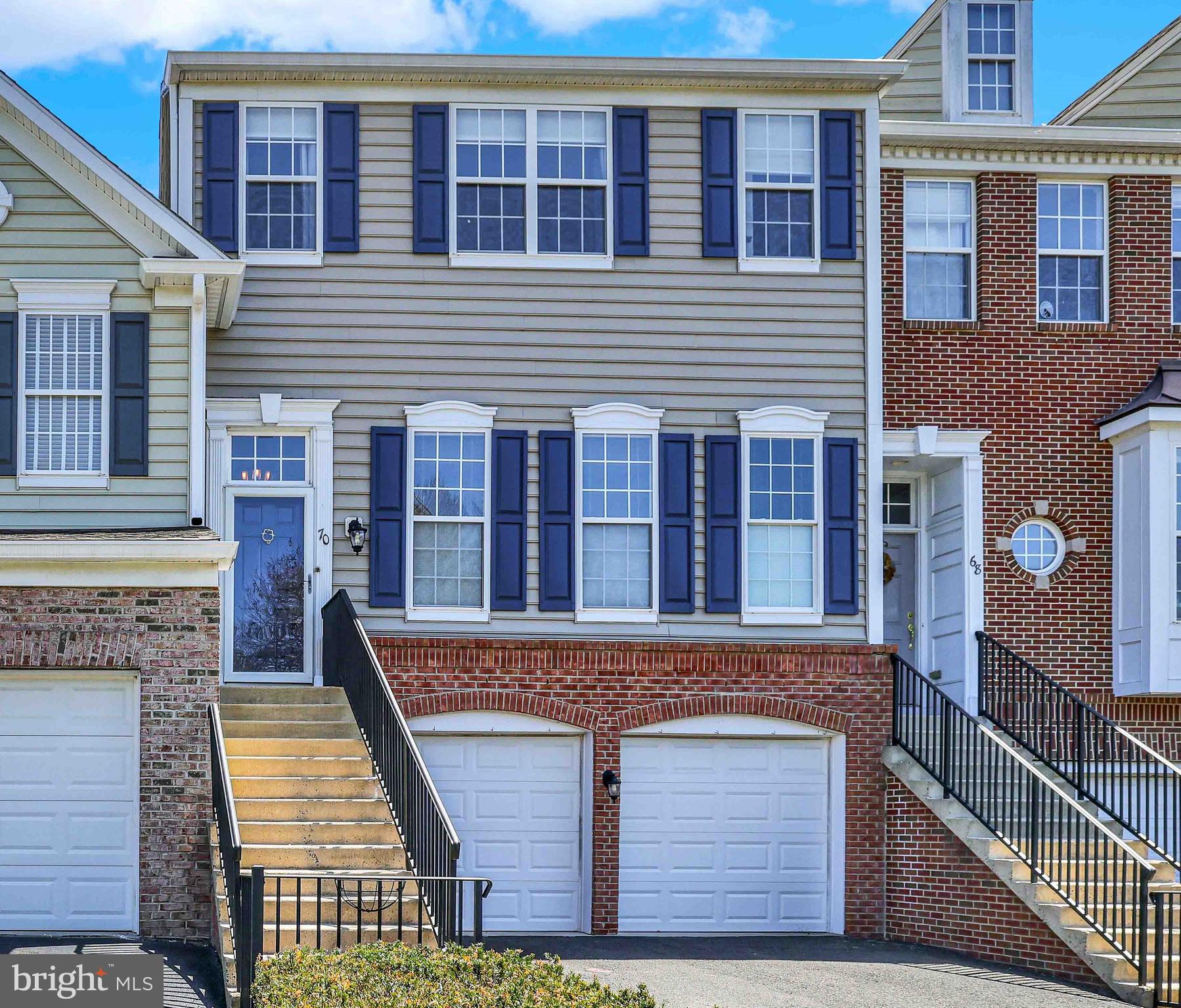 Hello Beautiful! This expanded Brandon II townhome served as the builder's model and is filled with open spaces and natural light with Mohawk Rev 7 foot, random width floors that were installed throughout the main level and follow a circular layout - perfect for those entertaining get togethers.  A two-sided gas fireplace in the Family Room (adjacent to the Kitchen) is flanked 10-foot doors separating the Home Office/ Den for utmost privacy. In the gourmet  kitchen, there are plenty of 42" brand new solid wood cabinets and granite counters, gray and white brick styled tile backsplash and new stainless steel appliances. A second story oversized deck is accessed through the sunny office.  A powder room and custom molding custom window blinds complete this level. Retire for the eve - upstairs in one of the spacious bedrooms. The master bedroom includes a huge walk-in closet with organizers, and a brand new master bathroom with double sinks, and an 8-foot luxurious shower with a shower head at each end frameless doors, and a private water closet with a new one-piece fixture. The laundry room is conveniently located on the upper level. A full bathroom is located in the hallway and shared by the second and third bedrooms that have their own spacious closets. Next we go to the lower level of the home  and find more living space. A  media room with 9' ceilings and  another spacious (4th) bedroom and another full bath - a great area for guests or au pair.  Also find access to the 2-car garage, and a large storage room and two additional closets down here. Sliders on this level lead out to a beautiful covered paver patio.  A Beauty to not miss out on!