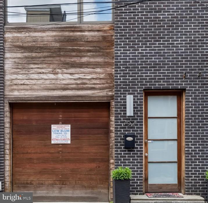 Welcome to this striking, contemporary townhome offering the perfect blend of modern design, functional living, and low-maintenance luxury. Thoughtfully built with clean architectural lines and high-end finishes throughout, this home stands out from the moment you arrive, in a small quiet side street. Premier location with garage parking for under $1 million!

The main living level is anchored by a designer kitchen featuring a waterfall-edge quartz island, stainless steel appliances, and a gas range—ideal for both everyday living and entertaining. Floor-to-ceiling sliding glass doors seamlessly connect the interior to a private outdoor space, creating a true indoor/outdoor living experience rarely found in the city.

Upstairs, generously sized bedrooms are complemented by spa-inspired bathrooms, one with a bath and the other with a frameless glass shower, modern vanities, and timeless finishes. The fully finished lower level provides flexible living space perfect for a home office, gym, or guest suite, along with an additional full bathroom and a laundry room. 

Additional highlights include hardwood flooring throughout, recessed lighting, lots of storage, and a private garage—an exceptional convenience in this location.