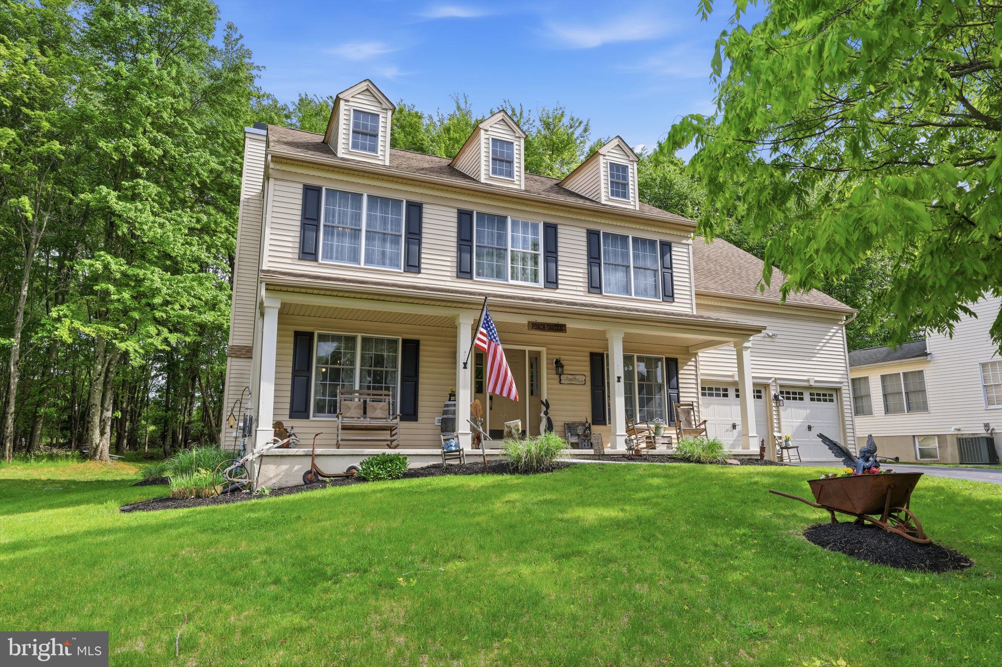 Welcome to this charming farmhouse inspired home tucked away on a private corner lot in the highly sought after Pheasant Point community of Newtown Township. Surrounded by mature trees and located within the award winning Council Rock School District, this beautifully maintained 4 bedroom, 2.5 bath home offers warmth, character, and a layout designed for everyday living and entertaining. From the moment you arrive, the covered front porch with classic rocking chairs creates an inviting, timeless feel. Inside, the two story foyer opens to hardwood flooring and a welcoming flow throughout the main level. The dining room offers an elegant space for gatherings, while double doors lead into the cozy family room where a brick front wood burning fireplace serves as the centerpiece. The family room opens seamlessly into the kitchen, creating a comfortable and connected living space. The kitchen blends charm and functionality with warm wood cabinetry, brick backsplash, stainless steel appliances, hardwood flooring, pendant lighting, and a bright breakfast area overlooking the backyard. Just off the kitchen, the patio provides the perfect setting for outdoor dining, summer grilling, surrounded by lush trees and natural privacy. Upstairs, the spacious primary suite offers a peaceful retreat complete with double door entry, a walk in closet, and a beautifully appointed ensuite bath featuring a soaking tub, glass enclosed shower, double vanity, and recessed lighting. Three additional bedrooms and a hall bath provide plenty of space for family, guests, or home office needs. The basement adds valuable flexibility and is currently used as an exercise and game room with additional storage space, while still offering future finishing potential for even more living area. Thoughtfully cared for over the years, the home also includes a newer water heater installed in 2019 and AC system replaced in 2016. Located just minutes from downtown Newtown, Tyler State Park, Rose Bank Winery, Clark Nature Center, and Noah’s Playground, with convenient access to I 95 for commuting to Philadelphia, Princeton, and New York City. A wonderful opportunity to enjoy everything this sought after Bucks County community has to offer.