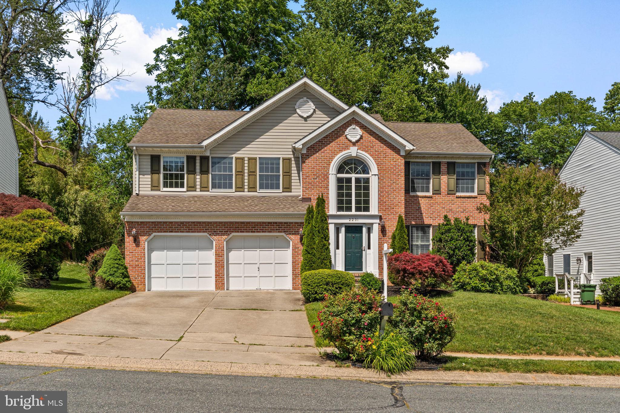 Spacious brick-front Colonial in desirable Hunters Run/Saddle Ridge, beautifully situated on a quiet cul-de-sac. A dramatic open-to-below foyer creates a memorable first impression with soaring ceilings and oversized windows that bring in abundant natural light. Hardwood floors extend through most of the main level, upper hall, and primary bedroom. The spacious open kitchen features granite countertops, stainless steel appliances, a refrigerator replaced in 2024, and a bright breakfast area surrounded by a beautiful three-sided bay window. A separate main-level laundry room offers convenient side-yard access, with washer replaced in 2025. The oversized primary suite includes a jetted tub and separate shower, while a generous secondary bedroom enjoys convenient access to the hall bath. The unfinished basement provides wonderful flexibility for future customization—recreation room, home gym, office, media room, storage, or more. Two-car garage adds everyday convenience and storage. Step outside to a tiered deck overlooking a private rear yard backing to trees. Recent major updates include furnace replaced in 2025 and water heater replaced in 2024. Blue Ribbon schools, nearby shopping and dining, and convenient commuter access complete this beautiful home.