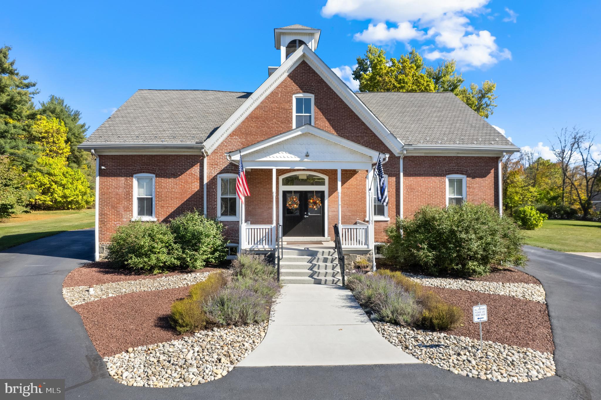 Welcome to 3062 Main Street, the former Sumneytown Schoolhouse in Marlborough Township, Green Lane. Zoned Mixed Use - Village Commercial, on 8.23 acres with the potential for subdivision of residential or commercial development. This historical brick building has a total of 5,494 sq ft of interior space. The front double door enters the office reception area, and overall is spacious, bright, and has neutral décor. There are 6 private office rooms, a central mail/copy area, a break room, a storage room, and a bathroom. The office, kitchen and basement were completely remodeled in 2013. The office is ADA compliant and a Generac generator services the entire building! Enter on the composite deck, through the decorative glass door into the open Kitchen/Living Room combination. With 12-foot ceilings, oversized windows, hardwood floors, and an abundance of natural light, the living space has a welcoming charm. Upstairs the second floor showcases 3 spacious bedrooms with exposed brick walls, original wood beams, and vaulted ceilings with track lighting. The primary bedroom has skylights and a walk-in closet the length of the bedroom. The basement is bright, clean and tidy, and contains utilities, with plenty of room for exercises equipment, additional storage, or finish an area for additional living/office space. Enjoy entertaining on the covered composite deck with exposed brick. Currently, 2,427 sq ft of the total is designated office space on the 1st floor and 3,067 sq ft of residential space on both the 1st and 2nd floor. This property has a great setup with connections to public sewer, natural gas and private well water. The property features an advanced security system and the HVAC system has 4 zones. Currently, there are 10 parking spaces with the potential to easily add a lot more if necessary. This is a perfect location for almost any business with the potential for future income from the additional acreage. Showings start Wednesday November 20th!