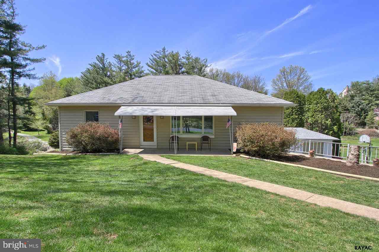 Lots to love in this Rancher. Home Sits on 1.3 ac. that overlooks a park like setting with small stream. Updated kitchen with raised panel cabinetry, solid surface counters and breakfast bar. Enjoy the spacious sun-room while soaking in your hot tub! Walk out Lower level family room or possible in-law quarters. Added bonus a detached workshop & 1 car garage.