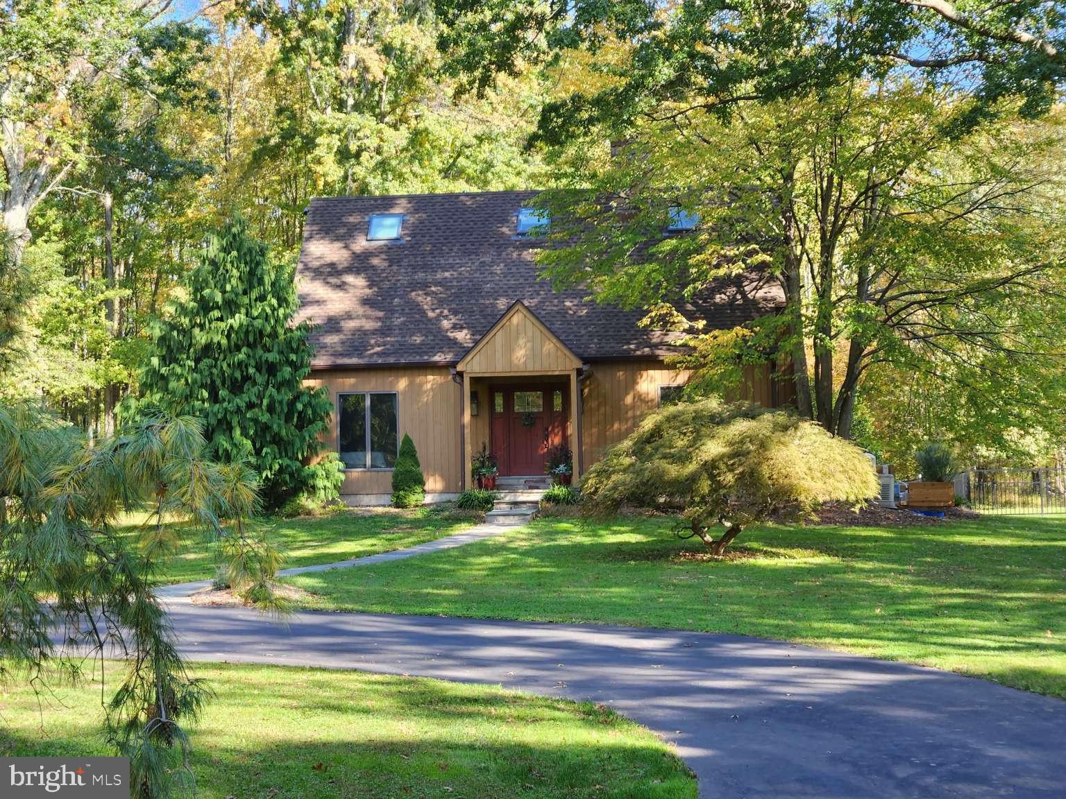 Set on over 14 acres of scenic land in the heart of Bucks County, this property offers the perfect balance of seclusion and convenience. Located near Doylestown, New Hope, and Lambertville, you’ll enjoy escaping to your own private retreat without sacrificing access to local amenities, artisanal shops, and outdoor adventures. Turn-key and offering plenty of charm and character, the property features a beautiful post and beam home with oversized windows, hardwood floors, high ceilings, floor to ceiling stone fireplace, updated kitchen and bathrooms, first floor and second floor bedrooms, and composite deck overlooking a stunning, heated bluestone swimming pool that blends seamlessly into the natural landscape. The property also features a detached 3 car garage with a modern second floor office with extensive built in cabinetry that provides 725 square feet of beautifully finished space for a home office or business. Surrounded by lush greenery and mature trees, the property features multiple hiking trails that allow you to explore the natural beauty that abounds. Additional features include a well-lit full basement with tall ceilings and ample storage space, integrated home security system, and Generac whole house generator. Whether you’re looking for a primary home or a weekend getaway, this property provides the perfect fusion of privacy and convenience. Don't miss out on this amazing opportunity to own your own piece of paradise.