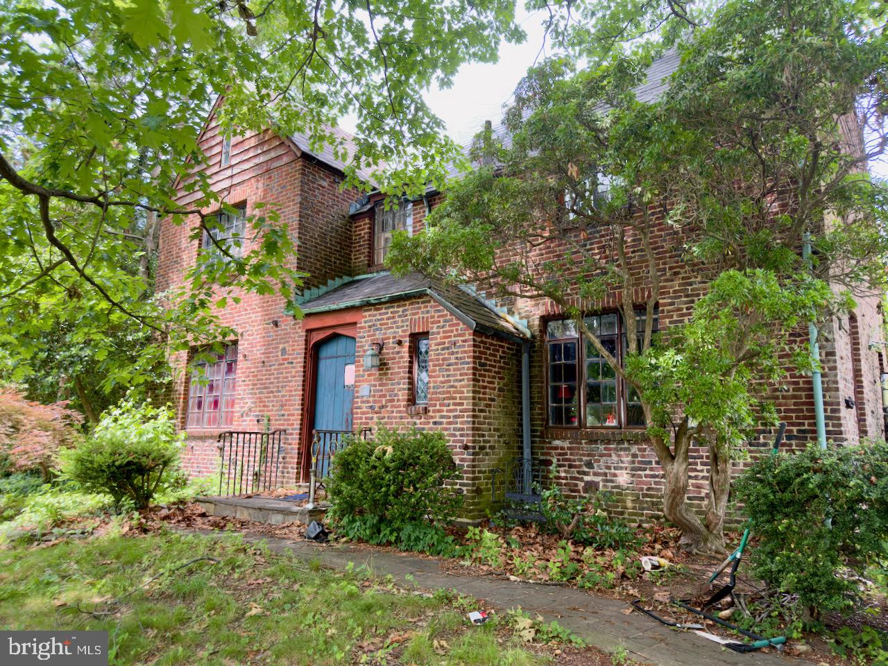 For the first time in over 45 years, one of Doylestown's original architectural treasures returns to the market. 265 Paine Street is not simply a house. It is a chapter of the borough's story, written in brick, slate, and Mercer tile by the hand that helped shape the town itself.

Designed and built in 1929 by A. Oscar Martin, this Tudor residence is the work of the architect who shaped Doylestown for over four decades, from the Mercer Museum addition to homes and landmarks standing at nearly every turn downtown. And this work in particular stayed in the family. His son Fred, an architect in his own right, made this house his home with his wife Emily, decades of Martin family life lived within these walls.

The craftsmanship of that era announces itself everywhere. Variegated brickwork laid with an artisan's eye. An original slate roof. Leaded casement windows. An arched plank entry beneath a copper-trimmed hood. And woven throughout, handcrafted tile from Henry Mercer's Moravian Pottery & Tile Works, made just a mile away, the signature of Doylestown's Arts and Crafts legacy. Inside, 2,930 square feet hold four bedrooms, one and a half baths, and the kind of proportions and detail that simply cannot be reproduced today.

Set on a rare quarter-acre corner lot in the heart of the borough's historic district, the home is a short stroll to the shops, restaurants, museums, and county seat energy that make Doylestown one of the most beloved small towns in America.
Now for the honest part, and the opportunity. This home requires a complete restoration and is offered strictly as-is. It awaits a buyer with vision, resources, and reverence for what stands here: original materials, an irreplaceable pedigree, and a canvas that comes around once in a generation. Homes like this are never built again. They are only saved.

The next 45 years of this home's story belong to its next steward. Schedule your private showing and come see what true historical craftsmanship looks and feels like.