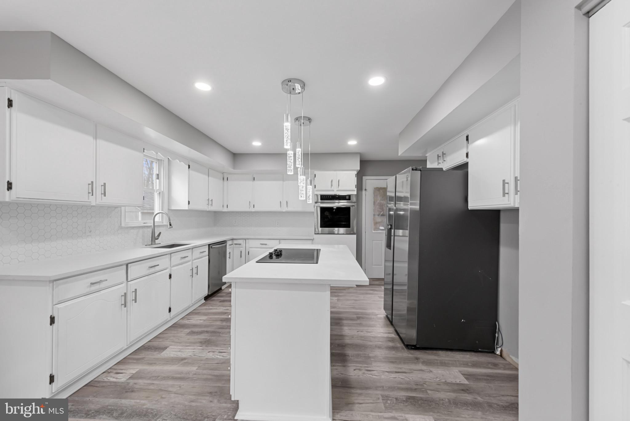$5,000 Closing Cost Available for accepted offer by 5/30/26.   No expense spared. Come Fall in Love with your new home!  Nestled in a sought-after neighborhood, this large home boasts modern updates including granite countertops, marble floors, modern Zen baths plus an abundant natural light throughout. With over 5,000 square feet of living area, this home includes multiple gathering spaces, ideal for entertaining or relaxing with family. The open-concept design flows seamlessly from the living room to the dining area and well-equipped kitchen.  The thoughtfully designed in-law suite is a true highlight, offering a private entrance, a cozy living area, a fully equipped kitchenette, a bedroom, and an en-suite bathroom. It provides the perfect blend of independence and comfort for family or guests. Step outside to a beautiful fenced-in yard, featuring a spacious deck , perfect for dining and summer barbecues.