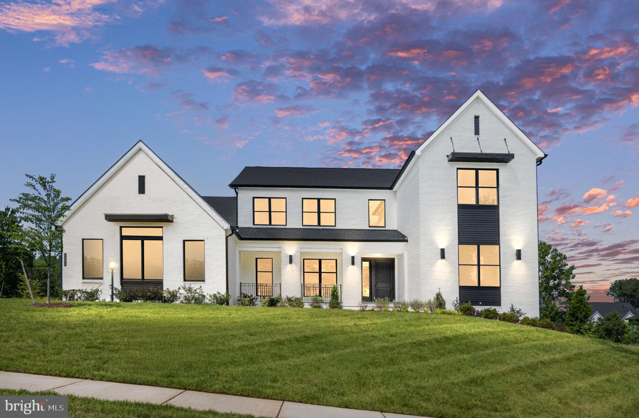 Elevate your lifestyle with this modern Contemporary home, designed to meet the needs of multi-generational families with dual primary bedroom suites. The open-concept kitchen showcases state-of-the-art appliances including a Sub-Zero 48" refrigerator, Wolf and Cove appliances, and KitchenAid amenities in the prep kitchen. Dual islands provide ample space for seamless everyday entertaining, complemented by an adjacent dining area overlooking a private backyard that backs onto a serene, wooded tree line, ideal for both casual gatherings and formal occasions. Enjoy natural light and serene views in the bright sunroom, conveniently located off the great room. Step through the impressive 15' expansive stacking doors onto the luxurious outdoor living deck, featuring a gas lanai fireplace, ceiling heaters for year-round comfort, a retractable screen, and easy-access stairs to the lower level. Indulge in luxurious entertaining in the impeccably finished recreation room, featuring expansive full-size windows that flood the space with natural light. This versatile area includes a private bedroom suite and bath, a dedicated media room, and additional finished space for your personal customization. Step outside to the patio beneath the sprawling luxury deck, perfect for al fresco dining and outdoor relaxation amidst the tranquility of your private backyard. This move-in ready home is perfectly timed for the new school year and situated in a highly coveted school district, ensuring an exceptional living experience. Enhanced by Anderson windows throughout, it offers unparalleled convenience to prestigious landmarks such as Wolf Trap National Park for the Performing Arts, The Boro, Tysons Corner Center, and Tysons Galleria—enriching your lifestyle with access to renowned cultural and shopping destinations just moments away