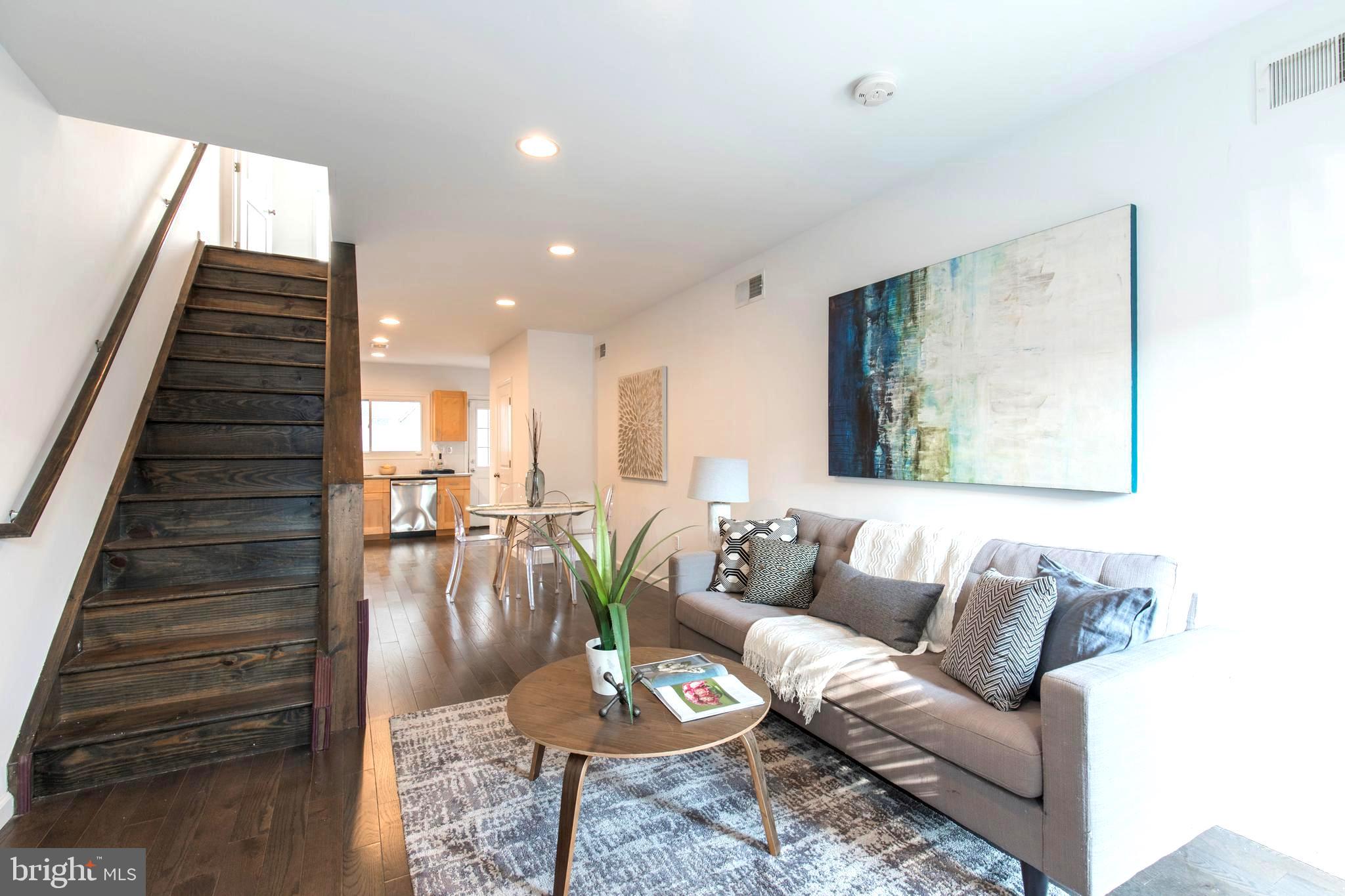 Nestled on a quiet side street just half a block from William M. Meredith School and moments from the acclaimed restaurants, cafés, and boutiques of Fabric Row, this move-in-ready residence truly offers the best of city living. This stunning 2-bedroom, 1.5-bath home welcomes you with brand-new wood flooring, soaring 9-foot ceilings, and a bright, open-concept main level featuring an eat-in kitchen and a first-floor powder room. The sun-filled kitchen features granite countertops, a gas range with a stainless steel hood, and a large picture window overlooking the spacious private patio. A modern patio privacy fence and a gated side alley provide convenient storage for trash and recycling.

Walking up the beautiful and wide hardwood stairs, you are greeted by two bright bedrooms and a newly renovated full bath. The west-facing bedroom features custom closet storage and sunny windows overlooking the patio below. The spacious owner’s suite offers vaulted ceilings, abundant natural light from east-facing windows, a west-facing skylight, and two custom built-in closets for exceptional storage and organization. The bright finished basement has a window and provides flexible bonus space ideal for a home office, gym, playroom, second living room, or additional storage. 

Combining thoughtful renovations, charming details, and an unbeatable location, this pristine Queen Village gem is one you won’t want to miss.