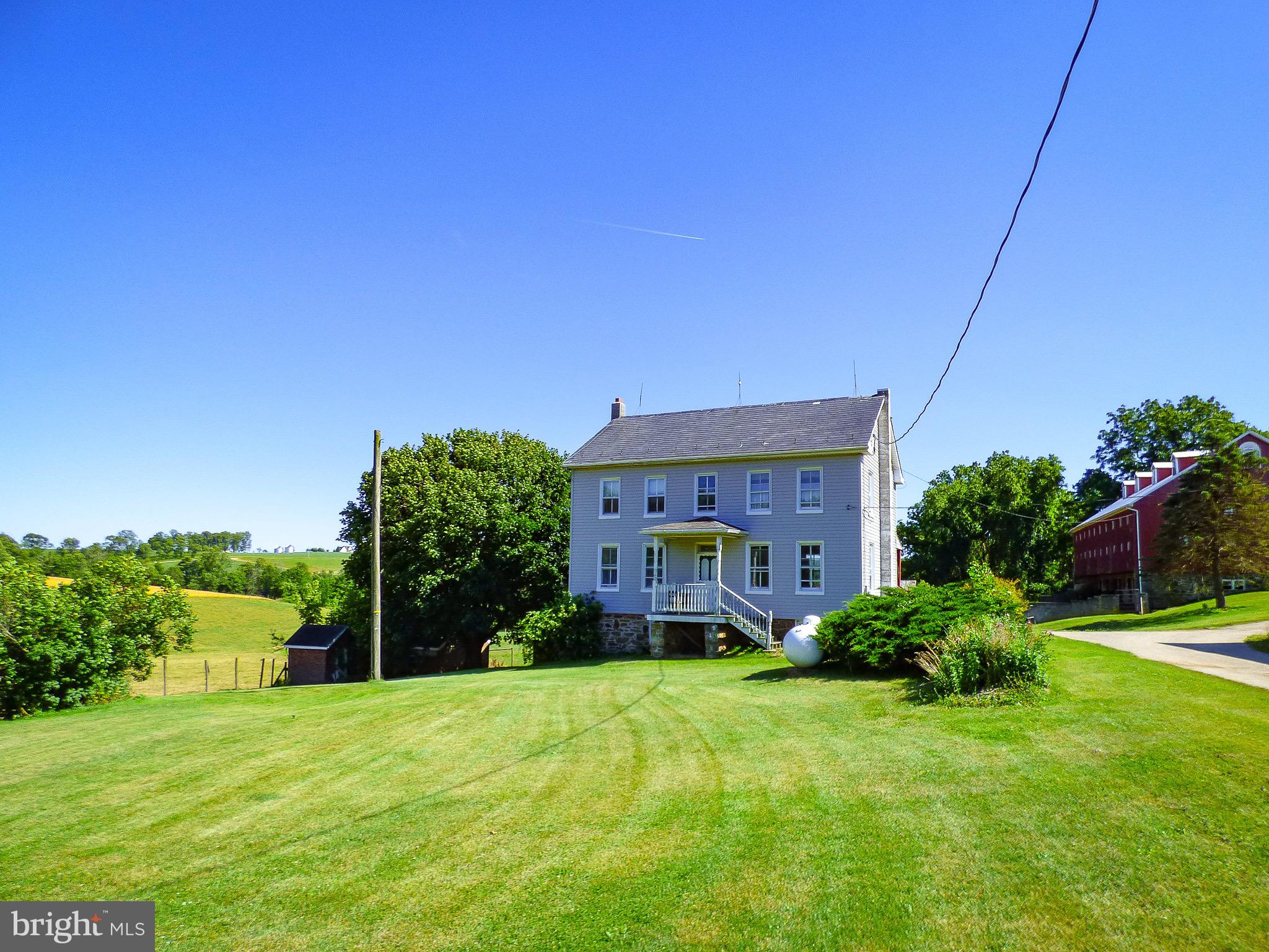 This 2,392 sq. ft. stone foundation, true brick farmhouse has been covered with siding, has a front covered stoop, a full length rear 1st floor covered rear balcony, replacement double hung, dual pane windows & maintenance free wrapped windows with storm windows & a wonderful view of the huge 1869 Stone bank barn, the grazing cattle & the rolling farmland which surrounds the homestead.