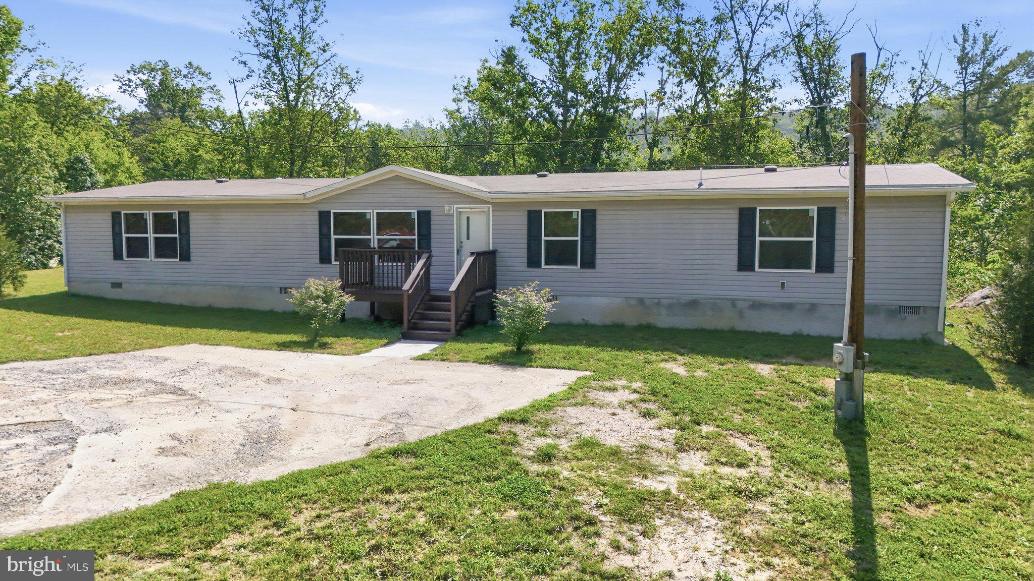 Price Improvement! Based on buyer and agent feedback, the price has been adjusted, offering an even better opportunity to own this unique property. Experience peaceful country living on 3.36, non-restricted, recently subdivided acres with this 5-bedroom, 3-bath home featuring mountain views and a private setting. Conveniently located just 20 minutes from Winchester, VA, and approximately 2 hours from Washington, D.C., the property offers the ideal blend of seclusion and accessibility. An additional outbuilding includes a wood stove for heat and access to well water via an exterior spigot, providing added versatility. Set on a permanent foundation, this property is ready for its next chapter.