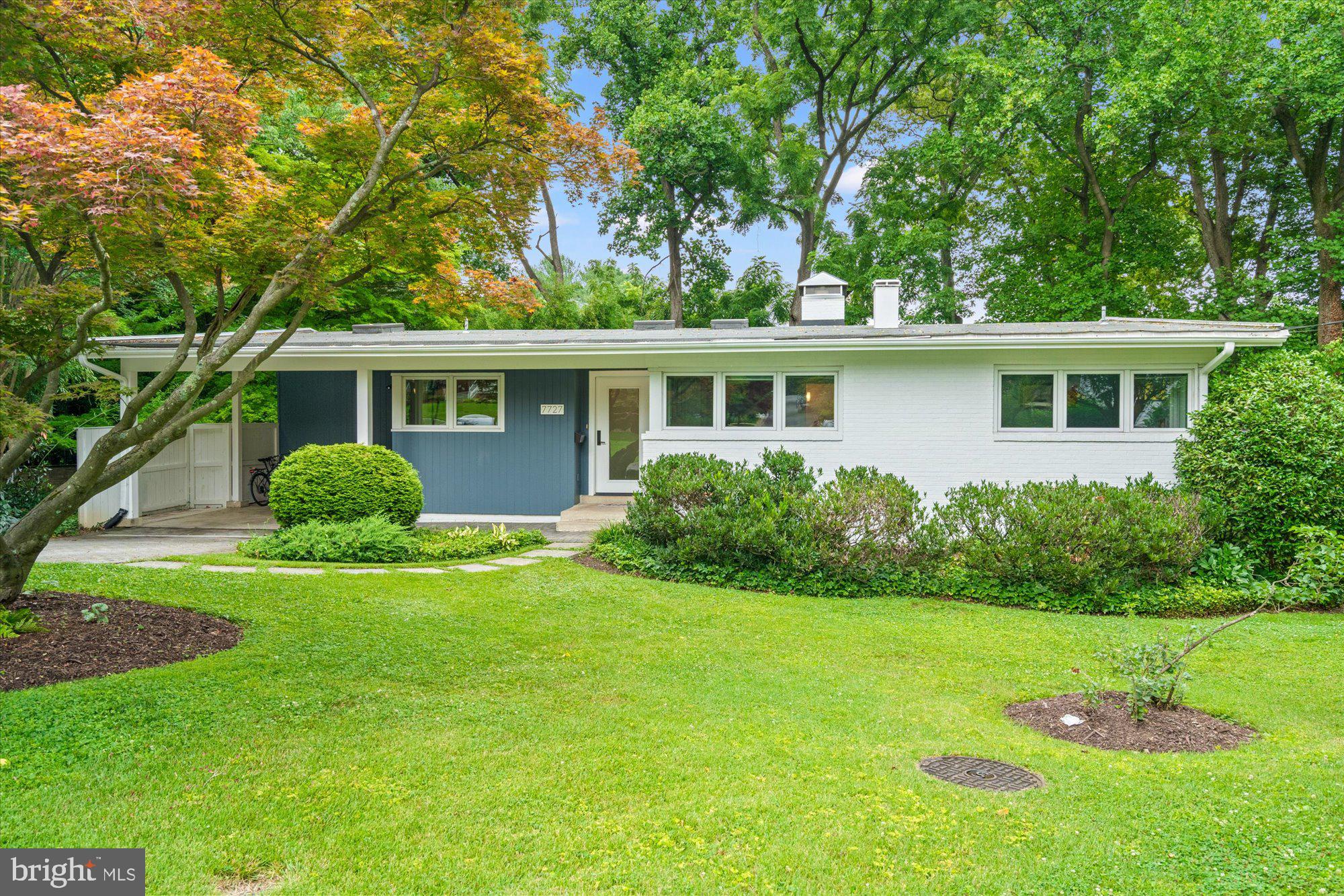 NEW LISTING! Open Sunday, July 12th from 2 - 4 PM! Experience timeless design and modern living in this exceptional Mid-Century Modern residence, ideally situated on a quiet cul de sac in the Rollingwood Terrace neighborhood. Set on a lush 0.38-acre lot, this architectural gem celebrates the clean lines, open spaces, and a seamless indoor-outdoor connection that define classic mid-century design.
Sunlight pours through an expansive wall of glass, illuminating airy living spaces with soaring ceilings, warm hardwood floors, and thoughtfully preserved architectural details. The open-concept floor plan is both sophisticated and functional, offering effortless flow for everyday living and entertaining alike.
The redesigned front entry and new front door welcome you into the dramatic main living space with peaked ceilings and new lighting. Anchored by a wood burning fireplace, the dramatic living and dining spaces are light filled and perfect for intimate gatherings or large-scale entertaining. The updated kitchen, featuring generous cabinet space, beautiful tiling, expansive prep space and designer lighting, opens directly to the spacious rear deck, ideal for dining al fresco or just unwinding after a long day. The private backyard, filled with mature trees and greenery, still provides plenty of room to play. A custom coat closet and convenient front main level office, both off of the entryway, provide heightened level of versatility. 
The home’s deceptively spacious layout features, five bedrooms, including four on the main level.  The brand new hall bathroom is ready of guests and family alike, with dual vanities, crisp subway tiling and excellent storage.  The king-sized primary bedroom has a deep, custom closet and convenient en-suite full bathroom.  
The large lower level provides tremendous flexibility with the home’s fifth bedroom with sitting area, an updated third full bathroom, a huge family room with a wall of glass and direct walk-out access to the rear yard and a second home office space that could easily be converted to a sixth bedroom if needed.  A deep storage, utility and laundry room complete the lower level. 
The Rollingwood Terrace neighborhood offers a rare combination of quiet residential charm and exceptional convenience. Enjoy easy access to Rock Creek Park, downtown Bethesda and Silver Spring, top rated schools and the cultural, dining, and shopping destinations of Washington, D.C. The neighborhood is known for its mature tree canopy, distinctive architecture, and strong sense of community, making it one of the area's most desirable places to call home.
A rare opportunity to own an iconic Mid-Century Modern home in an established neighborhood where architectural character, natural beauty, and an unbeatable location come together to welcome you home!