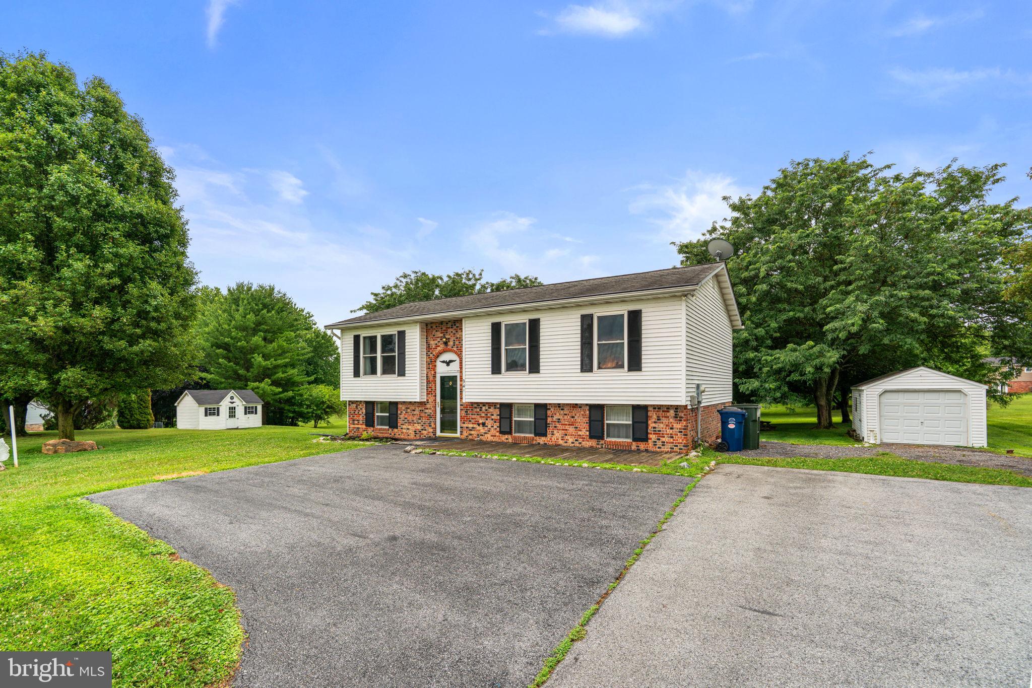 Extraordinary opportunity to grab a house on nearly an acre with panoramic views at a below market price.  The house needs a few touch ups here and there, but is totally livable and ready to occupy!  With nearly an acre you have room to roam and the rear of the property backs to trees while the front has a gorgeous pastoral view.  There is a living room with hardwood flooring, a kitchen with ample counter space that is open to a dining room that adjoins a massive sunroom overlooking the rear yard.  The primary suite is generously sized and has a dual entry bathroom to the hallway.  Two other bedrooms are on the upper level.  The lower level has a large family room with level walkout to a patio, a den that could easily be made a fourth bedroom, half bath and an enormous laundry/utility room.   The heat pump was replaced in 2023 along with the water heater.  The washer/dryer are five years old, refrigerator is only one year old and the stove is two years old.  Don't miss out on nearly an acre with a quick commute to Route 70, downtown Sykesville and all the spots on Route 26.