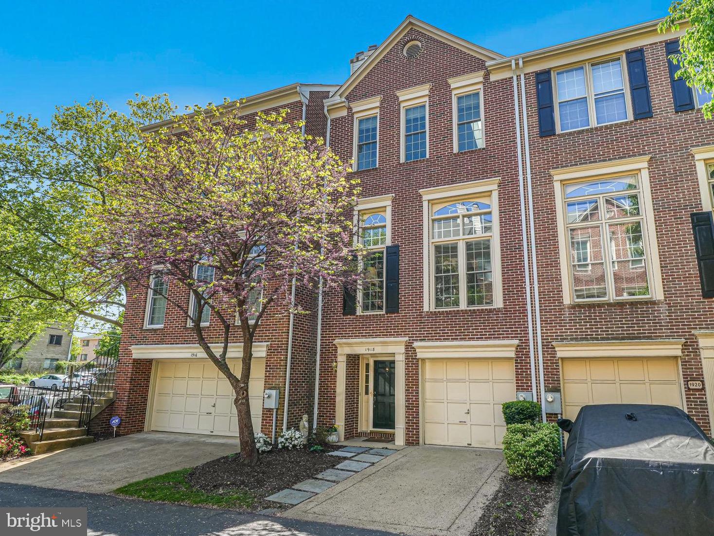 Sophisticated design and everyday comfort!  Located just blocks from the heart of Arlington's sought-after Clarendon neighborhood and just .6 miles to both Clarendon and Courthouse metro, this exceptional, light-filled townhome—celebrated in Arlington Magazine for its remarkable interior—has been meticulously updated and lovingly maintained.  This one-of-a-kind home manages to strike a seemingly impossible balance between bold and subtle, while the thoughtful layout makes each and every space efficient and usable.  The entry foyer was custom designed and features an ample size coat closet and access to the attached garage.  Just beyond, a cozy rec room with brand new carpeting and fresh paint offers the perfect flex space for a home office, gym, or informal living space and opens directly to a fully fenced brick patio.  A convenient half bath is also easily accessible.  Head upstairs and prepare to be wowed. The main living and dining space is dramatic yet inviting, with soaring 12-foot ceilings, custom built-ins, a gas fireplace, tailored drapery, and beautifully curated lighting.  The adjacent kitchen is both stylish and functional, with upgraded stainless steel appliances, Quartz countertops, a large pantry, and a bright South facing breakfast nook that feels effortlessly chic.  A secondary half bath rounds out this level of the home.  On the top floor you’ll find two secondary bedrooms—one with a clever set of built-in bookshelves (on wheels!) tucked neatly into a closet nook and the coziest of library vibes.  The secondary bedroom space features brand new carpeting and fresh paint.  The showstopping owner’s suite offers a peaceful escape, featuring a cathedral ceiling, elegant built-ins, and two spacious custom closets (including a generous walk-in with organizers). The en-suite bath is a truly elevated retreat with a marble double-sink vanity, marble flooring, skylight, jetted tub, walk-in shower, private water closet, and additional built-in storage.  Located with immediate access to the Lyon Village Shopping Center, one turn to Spout Run Parkway/GW Parkway, and less than 2 miles to Washington, DC's Georgetown neighborhood...first in class for shopping, dining, and Potomac waterfront views.  LIST OF NOTABLE UPGRADES:  New Carpeting in Rec Room, Guest Room, Owner's Suite Steps, Walk-in Closet (2025); HVAC System (2024), All New Windows and Sliding Glass Door (2023);  Roof (2012); Water Heater (2013); All new smoke/CO detectors (2025); Garage Door Sensor (2025);  Fireplace Serviced (2024); New Exterior Wood at Rear Bay Window (2024);  Kitchen Upgrades incl. Countertops (2021); Dishwasher (2020)