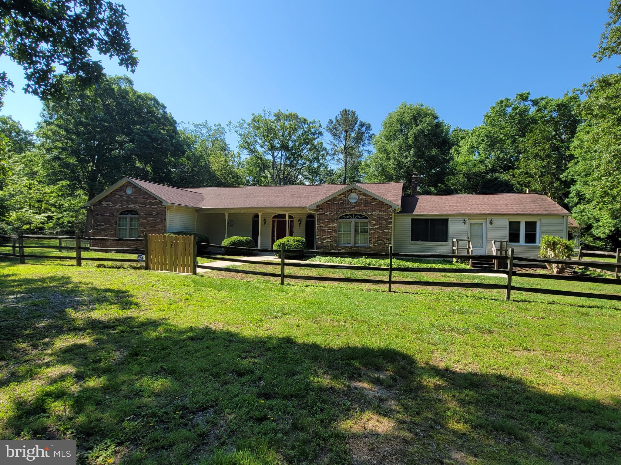 No HOA.  Large rambler on a 2.25 acre level lot with 2 driveways. 3 car detached garage.  2 spacious family rooms. Large galley kitchen with a new skylight. Hardwood floors. 4 bedrooms with a den that could be a 5th bedroom.  3 full bathrooms and a half bathroom off of the kitchen. Pantry in kitchen.  Wet bar in dining room.  Mudroom off of back door.  Large laundry room.  Large master bedroom has 2 walk in closets and separate shower and bathtub. 2 sinks with vanities. Guest bedroom with ensuite bathroom and large walk in closet. Optional second entrance for in-law suite. With 2 bedrooms, full bathroom and family room. 2 Large walk in closets.  Huge finished basement with family room and lots of storage and a separate entrance. Large level backyard with a huge new patio and lots of privacy.  Large shed/shop for tractor and garden tools.  All conveniently located near, schools,  shopping,  recreation,  and entertainment.  Lots of recent upgrades. Move in ready!