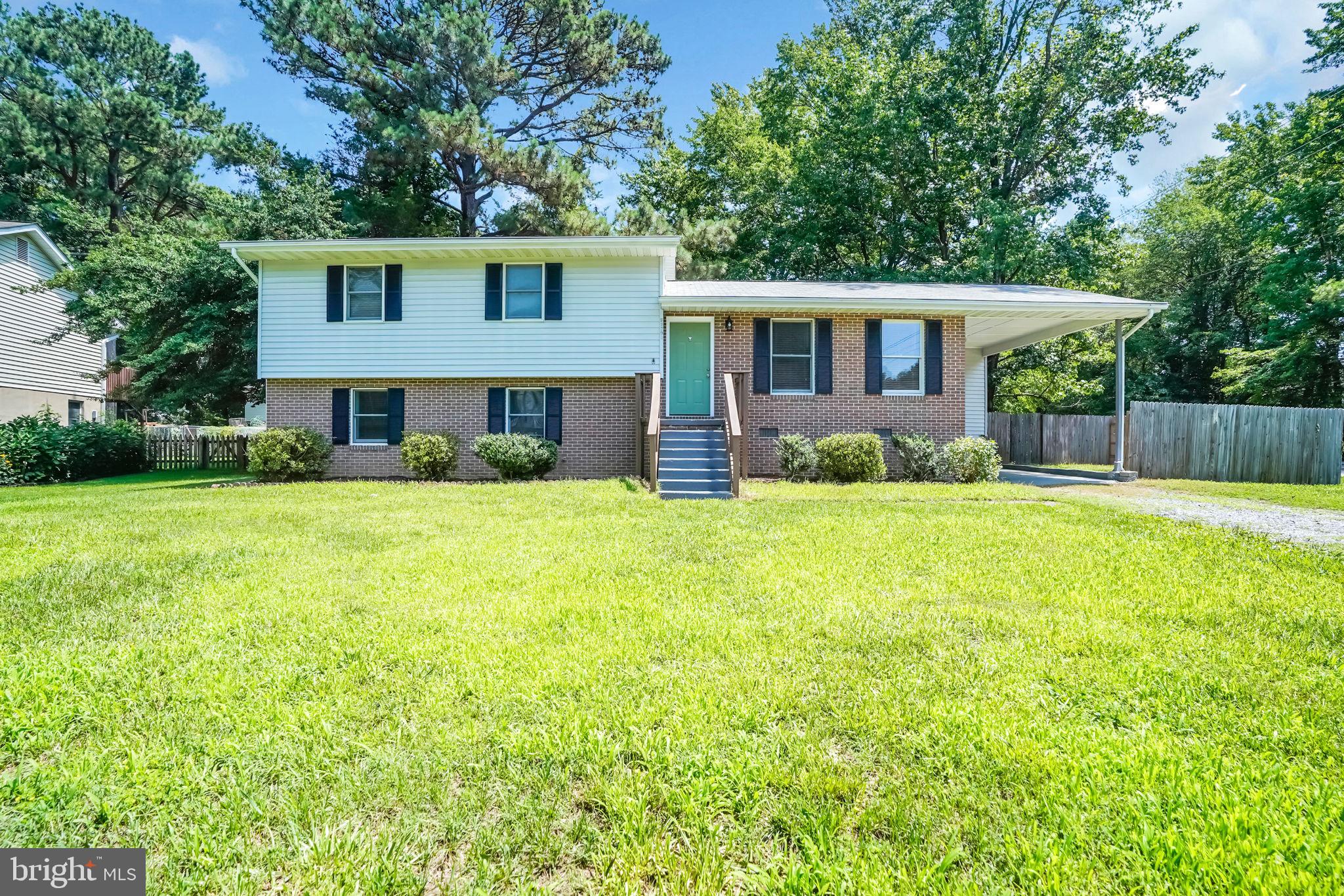 Move-in ready and fully renovated, this 4-bedroom, 3-full-bath home in Great Mills is designed for easy living and easy commuting alike — just minutes from Route 235 for a smooth drive to PAX Naval Air Station or points north. Inside, a brand-new kitchen anchors the main level with waterfall-edge quartz countertops, a full quartz slab backsplash, crisp white shaker cabinetry, matte black hardware, and new stainless steel appliances, opening seamlessly to the dining and living areas. New wide-plank luxury vinyl flooring, fresh paint, and updated recessed lighting carry throughout all four finished levels. Upstairs, the primary suite offers a private en-suite full bath alongside two additional bedrooms and a beautifully updated full hall bath. Down below, a spacious family room leads into a versatile walkout basement — complete with its own private entrance, a home office, a fourth bedroom, and a third full bath with laundry. A new HVAC system means peace of mind for years to come, while the fenced, tree-shaded backyard, large deck, and covered carport round out the outdoor space. Thoughtfully updated from top to bottom — this one is ready for you.