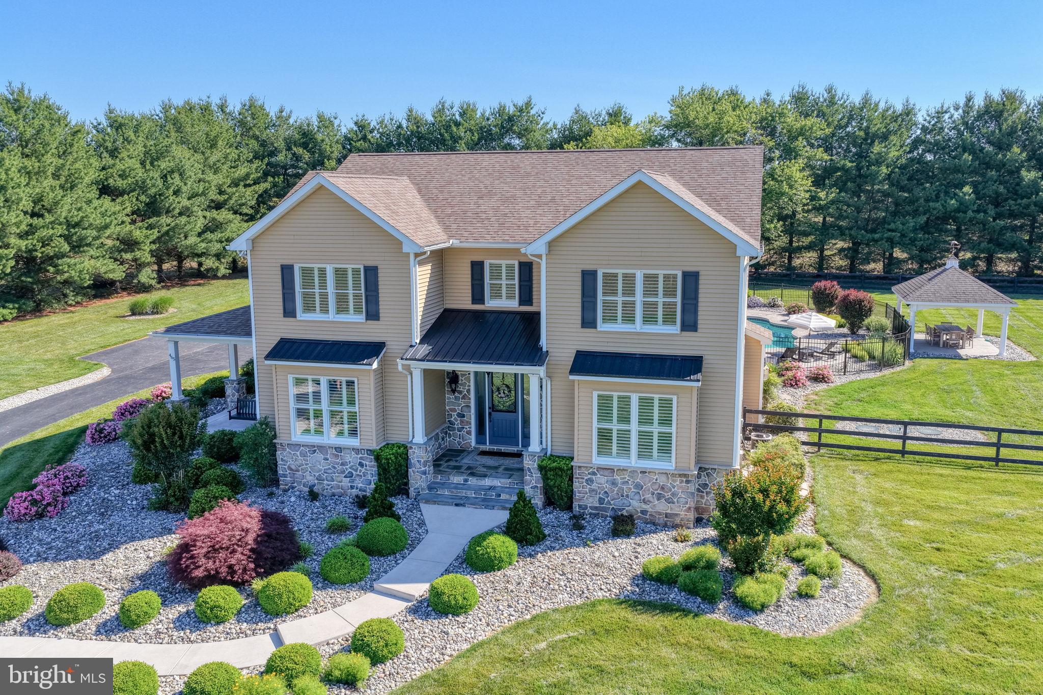 This stunning custom-built home, nestled on 1.76 acres of beautifully manicured grounds, is truly a showstopper. From the striking stone and vinyl exterior with a full wraparound porch to the gorgeous saltwater pool and Amish-built pavilion, every detail has been thoughtfully designed to create a private retreat ideal for both everyday living and entertaining. 
 
Step inside to an open-concept floor plan that seamlessly blends luxury and comfort. The expansive gourmet kitchen is a chef’s dream, highlighted by a breathtaking stone accent wall with a built-in fireplace. Features include granite countertops, a large island with an additional prep sink, a six-burner Viking stove with pasta arm, and a beautifully appointed wet bar with custom lighting and cabinetry. 
 
The kitchen flows effortlessly into the spacious family room with its own stunning stone fireplace, as well as a formal dining room and a versatile first-floor office, playroom, or guest room. 
 
This exceptional home offers four spacious bedrooms and two full baths, showcasing elegant finishes and thoughtful craftsmanship throughout. The partially finished basement provides even more living space, including an additional guest room, a large family/theater area, and a separate recreation space complete with a pool table area. 
 
Backing to peaceful farmland, this one-of-a-kind property perfectly combines luxury, charm, and functionality in an unforgettable setting. Additional highlights include an attached three-car garage and an impressive 30x40 detached garage featuring a pellet stove and four additional garage spaces. 
 
For boating enthusiasts, the public boat ramp on the Chesapeake Bay is just five minutes away. Conveniently located only 20 minutes from tax-free shopping in Middletown and close to Route 301, this home offers easy access to Philadelphia, Baltimore, and Washington, D.C. 
 
This is luxury country living at its finest — and the perfect place to call home.