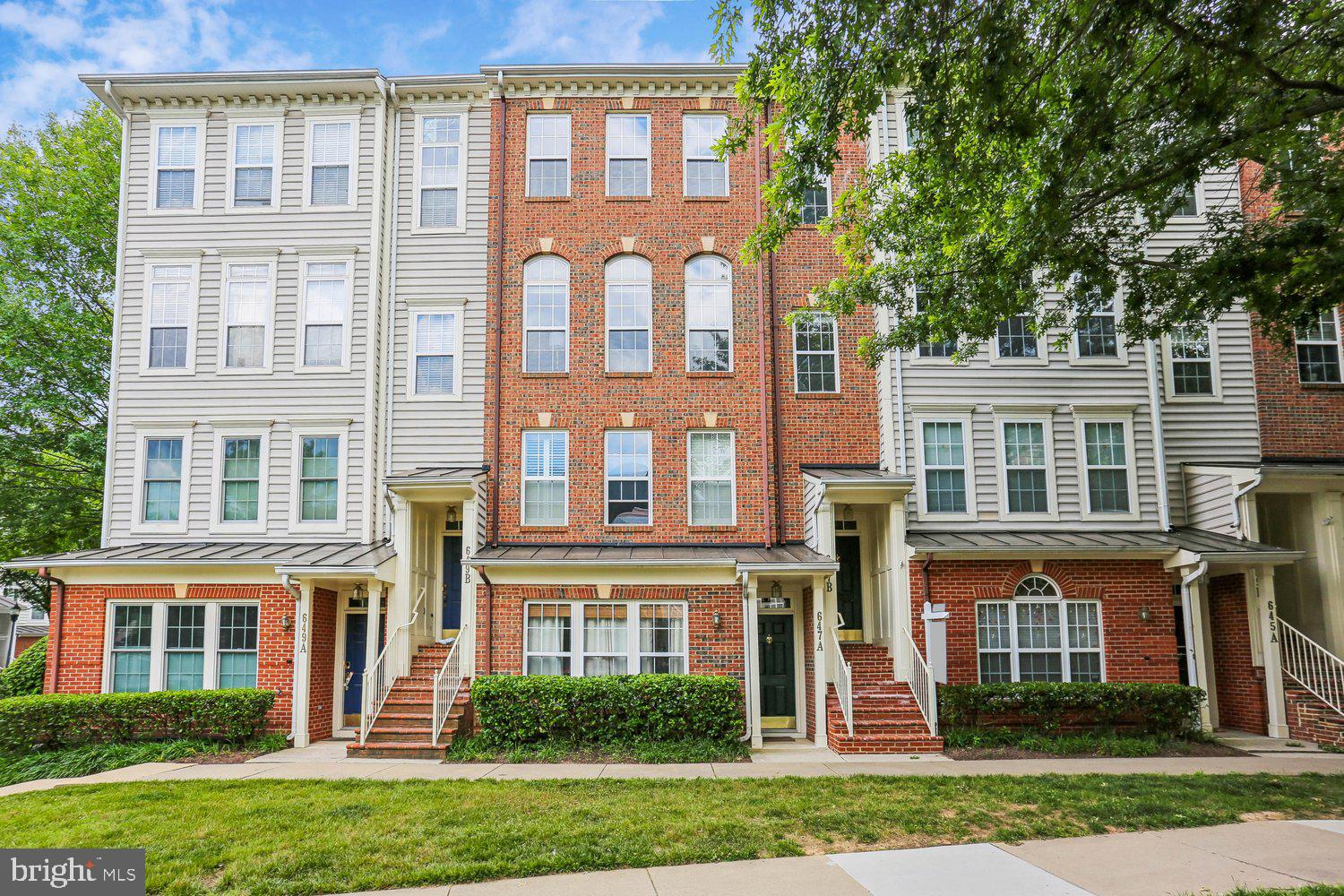 Beautifully updated townhome-style condominium offering spacious, light-filled living spaces and an exceptional layout. The main level features bamboo flooring, crown molding, recessed lighting, and a versatile open-concept living and dining area anchored by a striking three-sided gas-burning fireplace. The kitchen offers tiered granite countertops, white cabinetry, stainless steel appliances including a double-door refrigerator, built-in microwave, and gas stove, an undermount sink, pantry storage, and direct access to the sunny Trex deck - perfect for relaxing or entertaining. The dining area includes a lighted ceiling fan, while the spacious living room is filled with natural light from a triple window and arched transoms overlooking Main Street. An updated powder room with pedestal sink, decorator lighting, tile flooring, and a coat closet completes the main level.

Upstairs, carpeted stairs lead to a bright upper-level landing with decorator lighting. The primary suite features three windows with blinds, a lighted ceiling fan, and a walk-in closet with an organizer system. The en-suite bath includes a double-sink vanity, updated fixtures and hardware, decorator lighting, a medicine cabinet, and a glass-enclosed shower. The two additional bedrooms are large and bright and include roomy closets. A second full bath with tub/shower combination, a linen closet, and a conveniently located laundry room complete the upper level.

The entry level includes tiled flooring, pendant lighting, and access to the attached garage with lofted storage shelving and additional storage space. Set in an ideal location, this lovely home offers close proximity to the countless shopping, dining, and entertainment option this world-renowned new urbanist neighborhood offers as well as to major commuter routes and the Metro.