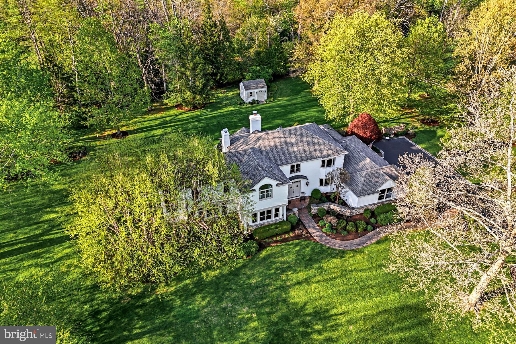 Welcome to this sun-filled, beautifully renovated residence set within the highly coveted Leopard Lakes community with  access to 11 acres of space surrounding a lake and private beach, offering swimming, kayaking, tennis or pickleball courts, a recently installed playground and private views from the walking path bordering the lake. Seize this  rare opportunity to enjoy this exceptional home offering both lake and creek views in a breathtaking setting. The current owners have spared no expense in transforming, expanding and upgrading this home with a bright open floor plan set on 1.5+ spectacular acres with specimen plantings and serene views at every turn. Exterior features include a stone-walled front courtyard, Belgian block-lined driveway, brick paths, private deck, sprinkler system, freshly painted exterior and full house generator.  The welcoming double doors with beveled glass open into a spacious entry foyer with open views of the sun-filled living and dining rooms, perfectly refinished and new light oak floors throughout the entire house, breakfast room  and  access to the other first floor living spaces including a  spacious office with built-ins and fireplace, fabulous new expanded gourmet kitchen with white custom Century cabinets with pull-outs, quartzite countertops, a service bar area, Thermador gas range with steam and convection ovens, bright breakfast room, adjacent family room with vaulted, beamed ceiling, wood burning fireplace and access to the rear deck and grounds, inviting sun room with vaulted ceiling, beam detail and access to the rear deck and backyard, a mud room/laundry room with plenty of closet and storage space and a beautifully renovated powder room.  Two staircases leas you up to the spacious second level which features an incredible primary suite owners’ magnificent retreat featuring a large bedroom with tray ceiling, cedar-lined window seat overlooking the back yard, elegant marble bathroom with dual vanities, spacious shower, soaking tub and private water closet,  dual walk-in closets with pocket doors, outfitted by California Closets, two additional bedrooms that share a renovated hall bathroom and a fourth bedroom with a walk-in closet and renovated ensuite bathroom. The lower level has also been partially finished by the current owners and offers a playroom/ gym space, a fully conditioned wine room and lots of storage. Additional features include freshly painted neutral decor,  modern architectural designs, custom moldings, newer Marvin windows, custom lighting, oversized 3-car garage with Tesla car charger and a whole house generator. Welcome home but feel like you're on vacation every day with the view of the lake, while hiking on the trails and listening to the babble of the flowing water, relaxing on the beach or taking your kids or grandkids to the new playground.  The lake and grounds are owned by Leopard Lakes Farm, Inc. Buyers pay this corporation a one-time transfer fee of $10,000 at settlement and annual dues of $2,659 per household. Just minutes from renowned public and private schools, endless recreational opportunities, clubs, shopping, restaurants and more.