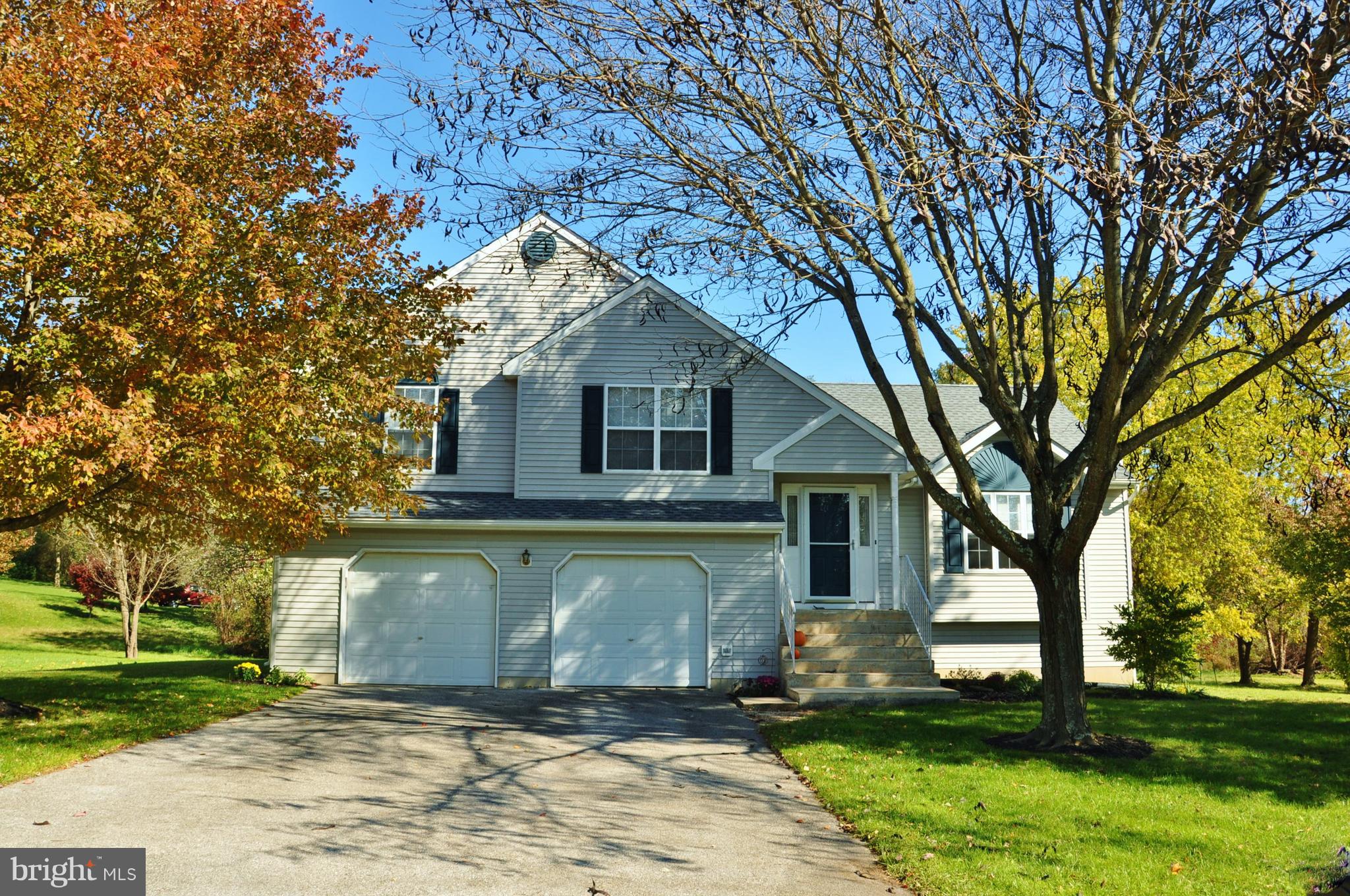 Spectacular home just minutes from the PA/MD line!   Meticulously maintained  and truly move-in ready!  Natural light pours in to the spacious living room with vaulted ceilings and access to the open dining area!  The cheery kitchen is a great place for enjoying  a cup of coffee or tea!  2nd floor features include a  master suite with a cathedral ceiling,  walk-in closet and a sizable master bath. The bath includes a double vanity,  soaking tub,  & separate shower.  Also located on the 2nd floor: a hall bath and  2 additional bedrooms! The lower level family room  offers a great place to relax and unwind and a  nice powder room.   And wait...there's more...the 2nd lower level features a large bonus/bedroom  and lots of storage!  Top it off with a 2-car garage and great flat yard and you've got it all!  Schedule your showing today!