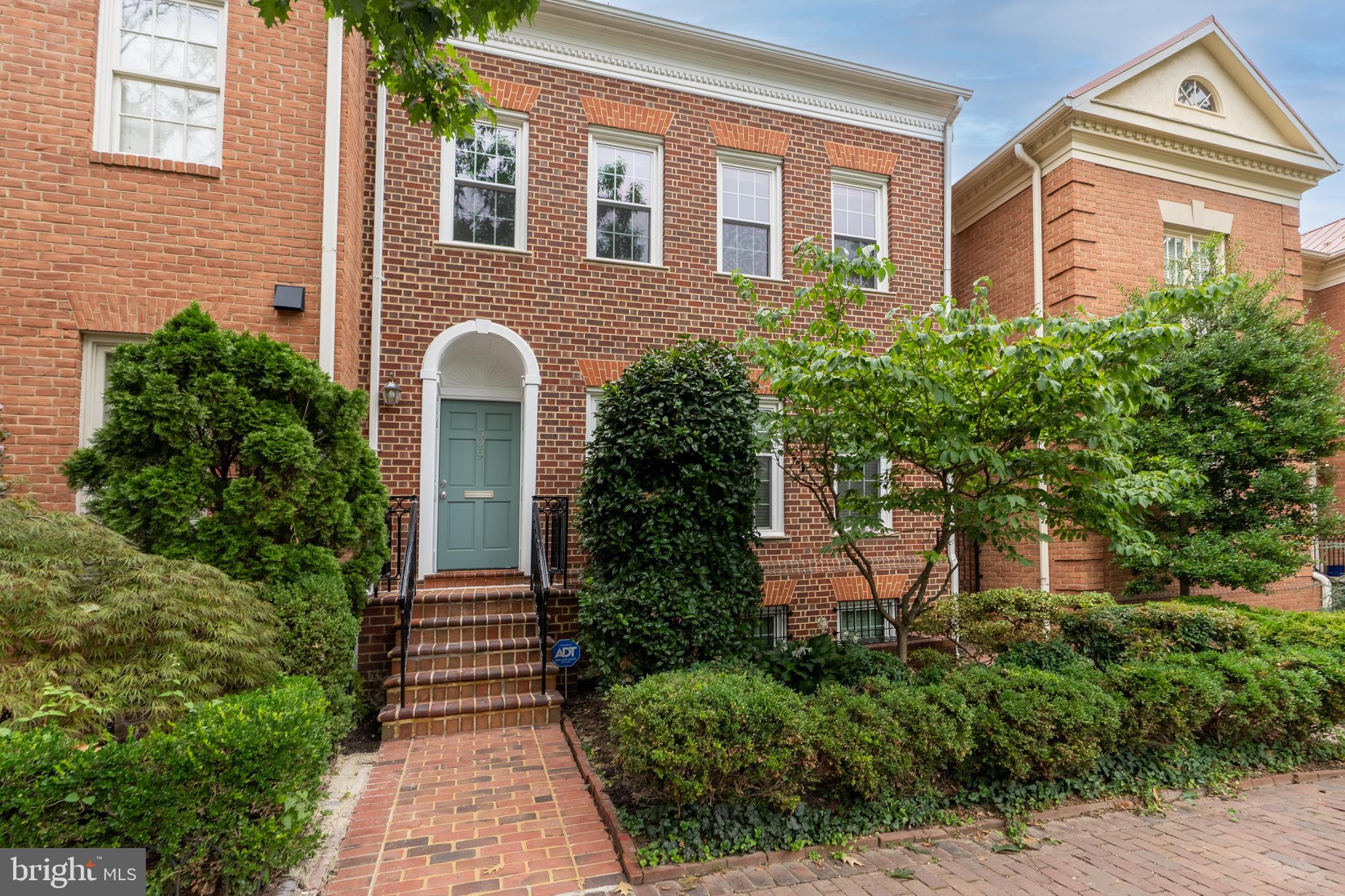 Welcome to this expansive 25-foot wide, 4-bedroom, 3.5-bath end-unit townhome in the sought-after Bulfinch Square community, offering over 3,450 square feet of beautifully designed living space across three levels. Perfectly located in vibrant Old Town Alexandria, you're just blocks from the scenic waterfront and Founders Park, and moments from the shops and restaurants of King Street. Step inside to a traditional yet open floor plan that lives like a detached home. The main level features high ceilings, hardwood floors, crown moldings, and recessed lighting throughout. The reimagined kitchen connects seamlessly to the dining room and presents white, soft-close cabinetry, stainless steel appliances, granite countertops, under-cabinet lighting, and a pantry. The inviting living room is anchored by a wood-burning fireplace with custom built-ins, and two sets of French doors leading out to the back patio perfect for relaxing or entertaining. The upper level is home to your own primary bedroom retreat complete with an ensuite bath and dual closets outfitted with custom organization systems. Two additional bedrooms and full bath on the upper-level and a generous guest suite found on the lower level, offer flexibility for family, guests, or home office needs.  Enjoy quiet evenings on the private brick patio or take a short stroll to all that Old Town has to offer. With 2 assigned parking spaces and low-maintenance living in a prime location, this exceptional property combines space, style, and convenience like no other. With easy access to the Metro, Amtrak, major commuting routes, and just minutes from Amazon's new HQ2, Reagan National Airport, and downtown DC, this home is a commuter’s dream