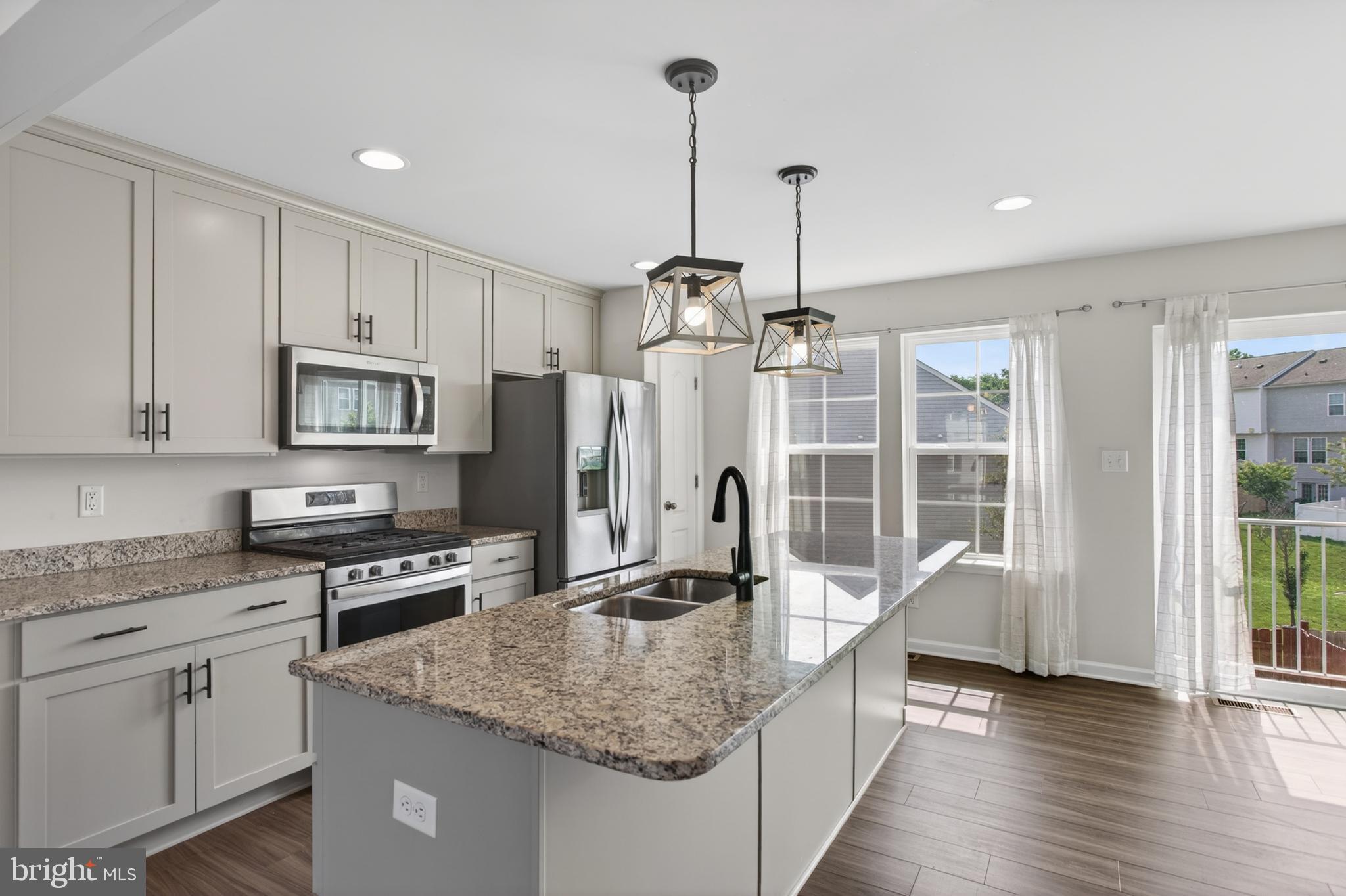 Welcome to 80 Capshaw Rd, an exceptional 3-bedroom, 4-bath townhouse located in the desirable Archer's Rock Community. This home shines with a kitchen featuring custom cabinets and a large island with a granite countertop, plus room for a table. There is luxury vinyl plank flooring on the main level, leading to the welcoming open-concept family room. The upper level offers a cozy, carpeted retreat. The primary suite has a walk-in closet and an attached bath with a walk-in shower. The remaining bedrooms are roomy, and there is an upper-level laundry. The basement provides additional space to use as you choose, with a half bath and access to the rear fenced yard. The home is ideal for buyers seeking a stylish, low-maintenance lifestyle without compromising on quality or space. Schedule your private tour today and see why this townhouse stands out from the rest.