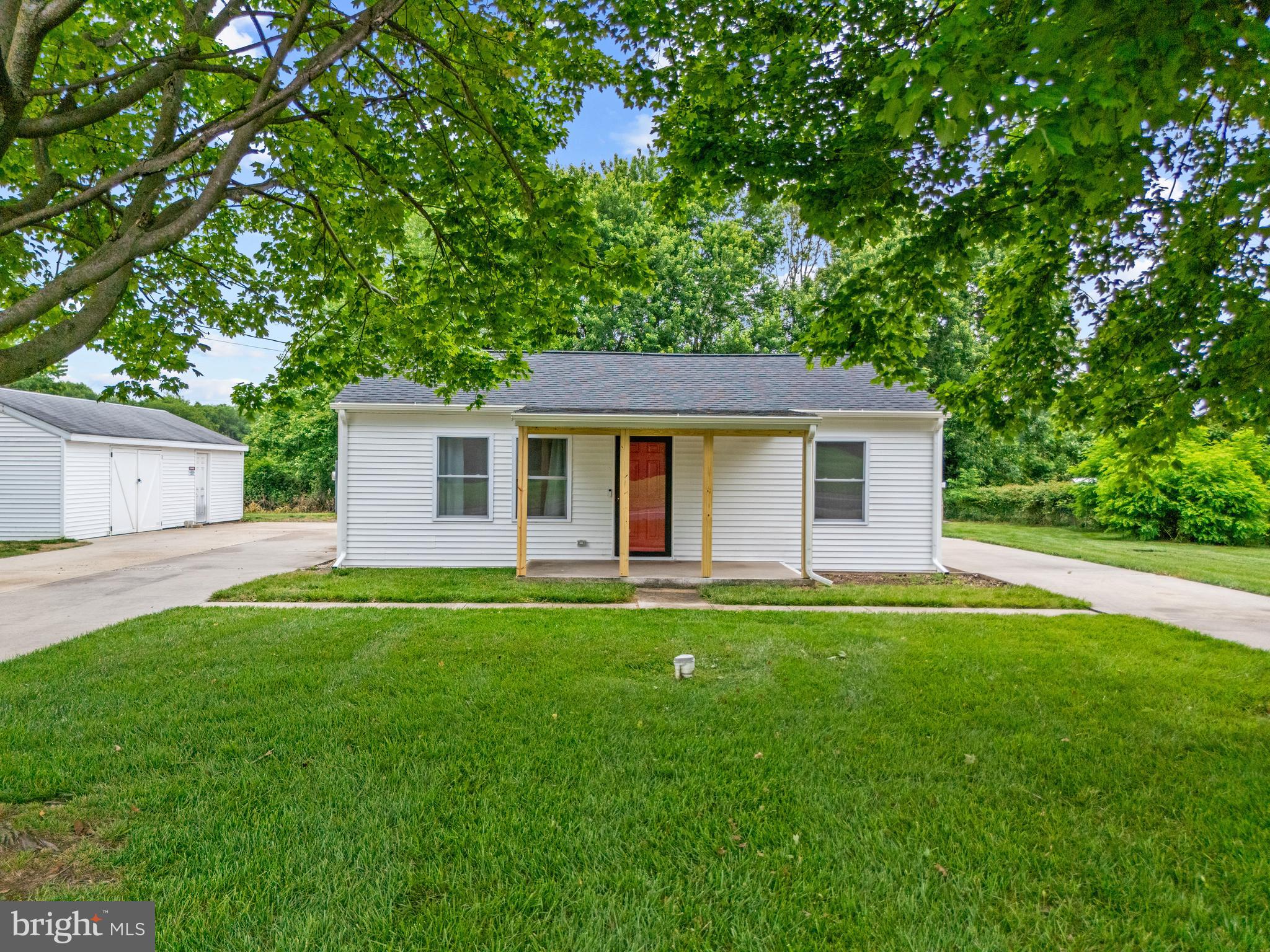 Welcome to this beautifully updated rancher in Milford sitting on just over half an acre. Featuring luxury vinyl plank flooring throughout, this home offers a bright, modern feel with an inviting layout perfect for both relaxing and entertaining. The updated kitchen shines with white cabinetry, stainless steel appliances, and a convenient pantry, flowing seamlessly into the main living space, while a functional laundry/mud room just off the kitchen provides access to the back patio and spacious yard—ideal for everyday living. Major system upgrades completed in 2023 include a new 30-year warranty roof, new 30 ft well installation, new heat pump HVAC system, new water heater, along with a water conditioning system installed within the last two years featuring a reverse osmosis system in the kitchen for enhanced water quality, PLUS a recently encapsulated crawl space with a dehumidifier and sump pump for added peace of mind. Down the hall, you’ll find three comfortable bedrooms, each equipped with ceiling fans and ample closet space, along with a stylishly updated bathroom. Outside, enjoy a beautifully landscaped and well-maintained yard with a lush, fertilized lawn, a wraparound concrete driveway, a large detached garage with a separate workshop area, an additional storage shed, and a concrete pad in the backyard offering potential for a future shed or outbuilding. Conveniently located east of Route 1, this move in ready home provides easy access to shopping, dining, and nearby beaches! Don’t miss this opportunity, schedule your private tour today!