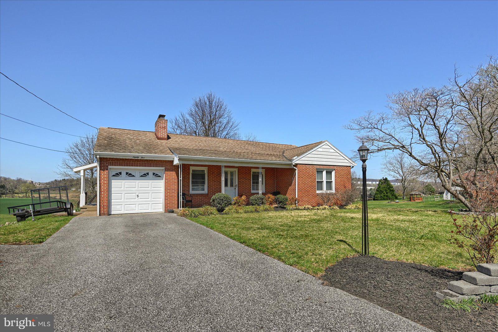 Wonderful Brick Rancher in a Great  Convenient Location.   The Curb Appeal with the Decorative Front Porch catches your attention.  Upon entering you find a spacious Living Room with Hardwood Floors and a Gas Fireplace.  Great space for entertaining.  The Formal Dining Room is perfect for Family Gatherings.  The Kitchen has Granite Counters and Ceramic Backsplash and the corner Dining Area has windows and natural light overlooking the country side.  Off the Formal Dining Room is a Four Season Room with Skylight and Surround windows and Sliding Glass Door leading to  the Deck and Back yard.  All 3 Bedrooms have Ceiling Fans, 2 with Hardwood Floors, 1 with Luxury Vinyl.  The Bathroom has Ceramic Walls and Floors and adds class to finish out the first floor.  The Basement has a Family Room with Wood Fireplace and the Utility Rooms could be used for future entertaining areas.    This house has fields behind it and Fabulous Views.  The Lucky New Buyer is Going to Love It!