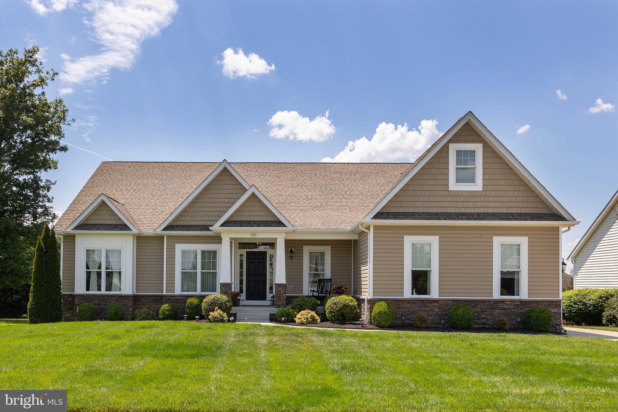 Discover the charm of this beautiful custom Craftsman-style home nestled in the desirable Ravenwing community. Built in 2018, this residence boasts a perfect blend of contemporary design and classic comfort, featuring four spacious bedrooms and three full bathrooms. Step inside to find an inviting open floor plan that seamlessly connects the living, dining, and kitchen areas, ideal for both entertaining and everyday living. The kitchen is a chef's dream, equipped with upgraded countertops, stainless steel appliances, and a generous island, perfect for casual meals or gatherings. Enjoy cozy evenings in the family room, complete with a stunning gas fireplace framed by elegant stonework. The primary suite offers a serene retreat with a spacious walk-in closet and a spa-like bathroom featuring both a walk-in shower and a relaxing tub. Additional highlights include solid hardwood and luxury vinyl plank flooring, recessed lighting, 9-ft ceilings, and thoughtful upgrades throughout, including the convenient main-floor laundry.  The lower level offers a spacious recreational room, a bedroom,  and a full bath.  Storage, there is a  large workshop/hobby room & also a storage room.  Outside, the beautifully landscaped & lot spans 0.27 acres, providing ample space for outdoor activities. The lot has a beautiful covered porch and lawn, with the rear lawn offering a place to unwind, all set amid lush greenery. The attached three-car garage and concrete driveway provide ample parking for you and your guests. With energy-efficient appliances and thoughtful security features, this custom-designed home is perfect for modern living. Experience the warmth and comfort of this exceptional property, where every detail has been carefully considered to create a true sense of home.  Home is where the heart is, and you will fall in love with 135 Kinross Drive as soon as you arrive.