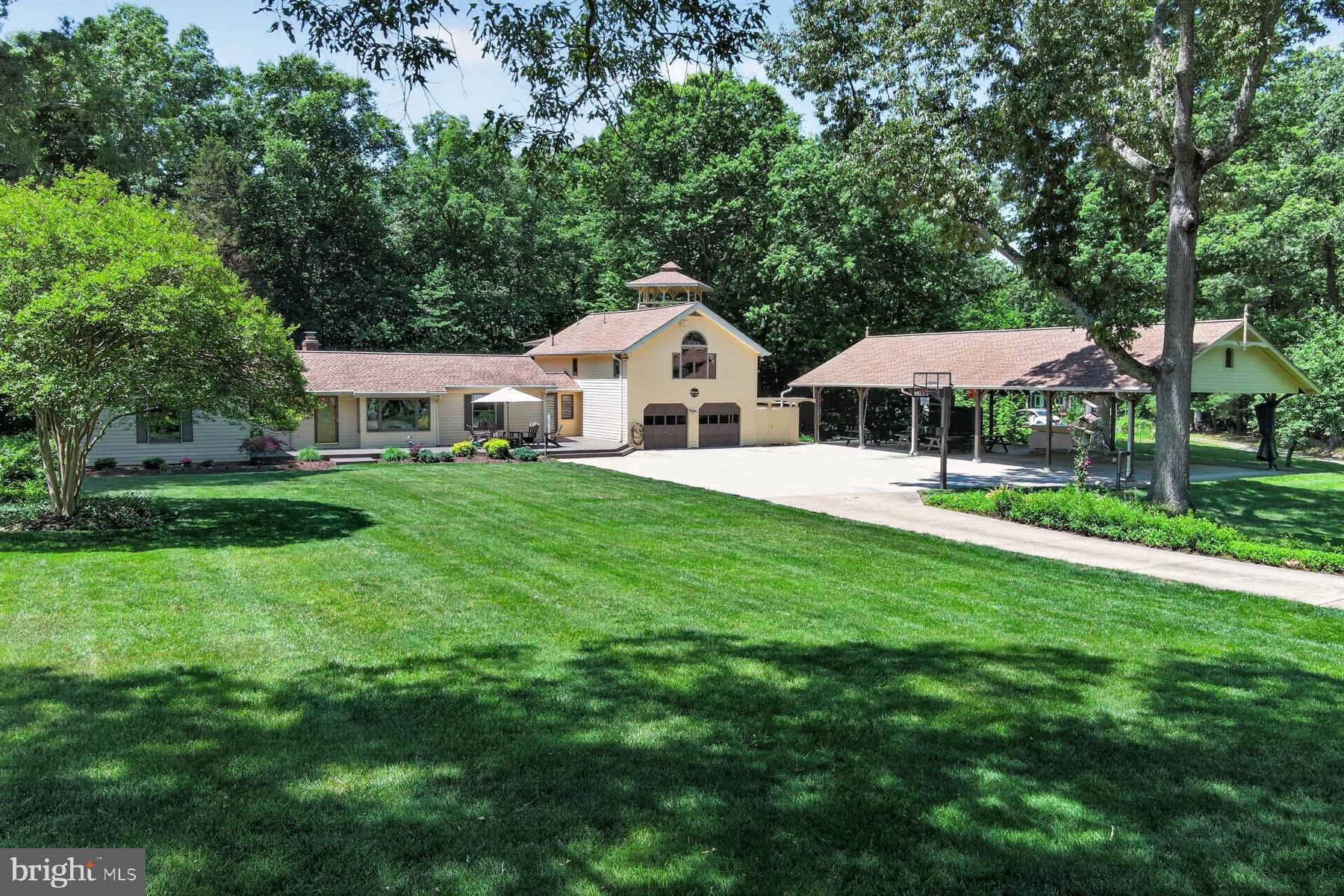 THE HOME<br> <br> 
At 3,724 square feet on 6.27 private acres, this five bedroom, four bathroom home strikes a balance that larger houses often miss — genuinely cozy, with rich wood floors, wood-trimmed windows, and rooms that invite you to settle in, yet spacious enough to live, work, and gather at any scale. It has been lovingly maintained within one family for multiple generations. Roof is architectural shingles (replaced in 2018) with gutter guards. Two cozy fireplaces. Double-paned Andersen windows. <br> <br>

A connected full suite functions equally well as an in-law apartment, a nanny quarters, or a private primary oasis — thoughtfully separated for independence while remaining part of the home. It has also been used as a full artist’s studio. It is the kind of addition that quietly transforms how you can live day to day. <br> <br>

THE OUTDOOR SPACE<br> <br> 
The grounds surrounding the home are lush and green with many opportunities for admiring flora and fauna. This home is nicely positioned on one of the paved roads in the community (deeper within the community the roads are gravel) with a paved driveway that winds amongst mature trees toward the home. The attached two-car garage currently serves as a fully equipped carpentry workshop, with flexible potential for vehicles, a studio, or storage. The pavilion carport can house an additional five cars. A separate outbuilding shelters lawn equipment. <br> <br>

The property has been designed — and deeply lived in — as an entertainer's destination. The grand pavilion anchors the outdoor space; large enough to host a wedding on site (which it has), it is equally suited to intimate summer dinners, crab boils, a concert on a crisp fall evening (curtains can quickly be pulled around to keep out wind or rain)— the kind of gathering space that becomes a family legend. It also includes a wind-down staircase and electronic lift with an extensive floored storage space in the eaves. An attached winch helps pull heavy cargo from a truck bed. <br> <br>

Multi-level decks wind through the tree canopy, anchored by a stamped concrete patio and custom tiki bar. A fantasy playground, woven into the wooded landscape, gives every generation a reason to stay outside. Walk into the additional acreage behind the house and play in the beautiful creek. <br> <br>

THE COMMUNITY<br> <br> 
The Moyaone Reserve is one of the most distinctive communities in the Washington metropolitan area — a 1,400-acre wooded enclave in Accokeek, Maryland, listed on the National Register of Historic Places just 10 miles south of the beltway. It sits within Piscataway Park, a 5,000-acre national park along the Potomac River, positioned directly across the water from George Washington's Mount Vernon. Federal scenic easements — established by Act of Congress and enforced by the National Park Service — protect every property here in perpetuity, preserving the rural landscape and the historic viewshed from Mount Vernon. This is not a developer's covenant. It is an agreement with the American people. <br> <br> 

The Moyaone Association is a voluntary community association, with a purpose that extends well beyond property values: to sustain the Reserve's rural character, historic identity, and local ecosystem. Residents enjoy a community pool, community pavilion, community garden, grill house, basketball court, playground, tiki refreshment hut, an active social calendar, and easy partnerships with neighboring institutions including the Alice Ferguson Foundation at Hard Bargain Farm, the Accokeek Foundation at the National Colonial Farm, and the Accokeek Artists Alliance. <br> <br>

The pace is slower here yet connected and vibrant. Enjoy every creative and nature-connected pursuit you can imagine — with good company. Commuting is easy to National Harbor, DC, Alexandria, Arlington, National Landing, Joint Base andrews, Joint Base Anacostia-Bolling.
