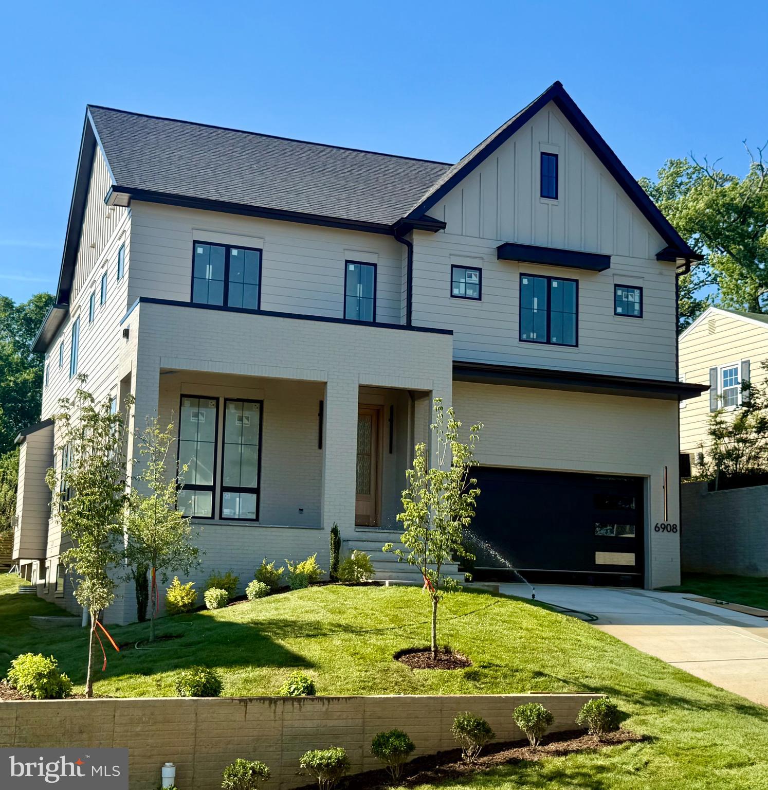 Scheduled for completion in June 2026, this exceptional new construction home by Randhawa Built offers the rare combination of sought-after McLean schools and the walkable lifestyle of Falls Church City. A highly regarded local builder with three decades of experience crafting custom homes in the Falls Church and McLean communities, their latest build is a 5-bedroom, 5.5-bath home with home office, screened porch, 2-car garage, ideally located with easy access to West Falls Church Metro, Founders Row, Birch & Broad, parks, playgrounds, restaurants, shops, movie theaters, High Point Pool, and the Washington & Old Dominion Trail (W&OD Trail).

Designed for daily living and effortless entertaining, the main level sets a high bar: 10-foot-plus ceilings, sand and stain red oak select flooring, custom millwork, and designer lighting throughout. At the center of the home, the chef’s kitchen showcases a Taj Mahal quartzite waterfall island with seating, a 60-inch Wolf gas range with pot filler, custom-integrated Wolf hood liner with 1,200 CFM blower, 48-inch French door Sub-Zero refrigerator with freezer drawer, and Cove dishwasher. A large pantry and smartly designed mudroom with direct garage access keep daily routines running smoothly. The breakfast eating area is next to the kitchen conveniently designed for daily use, with a separate formal dining room perfectly sized for entertaining.

The living area is anchored by a gas fireplace, with a full wall of glass doors opening to a screened deck overlooking a flat, private backyard. A wet bar with integrated glass rinser and custom fold-up pass-through window to the porch creates an exceptional indoor-outdoor entertaining experience.

The upper level consists of the primary suite overlooking the backyard, complete with integrated bedside lighting, a linear gas fireplace, massive dual customized walk-in closets, and a bathroom with separate vanities, oversized shower, and freestanding soaking tub. Each of the three secondary bedrooms includes its own ensuite bath and custom walk-in closet, thoughtful details that matter when the house is full.  A huge, light-filled laundry room with sink, quartz countertops, and built-in shelving completes the second floor.

Carefully planned grading and lower-level window locations allow for an abundance of natural light throughout the lower level. This level includes a private fifth bedroom and bath, a dedicated office or fitness room, open recreation and game areas, a second wet bar with quartzite waterfall counters and wine refrigerator, as well as generous storage throughout.

The exterior façade offers subtle hints of modern design while blending seamlessly with the surrounding neighborhood.  The front exterior feels grounded and well-balanced, with a substantial presence highlighted by a large covered brick patio, HardiePlank siding, and Andersen 400 Series windows.

A well-executed home by a designer and builder who has earned his reputation for quality, in one of Northern Virginia’s most desirable and convenient communities.