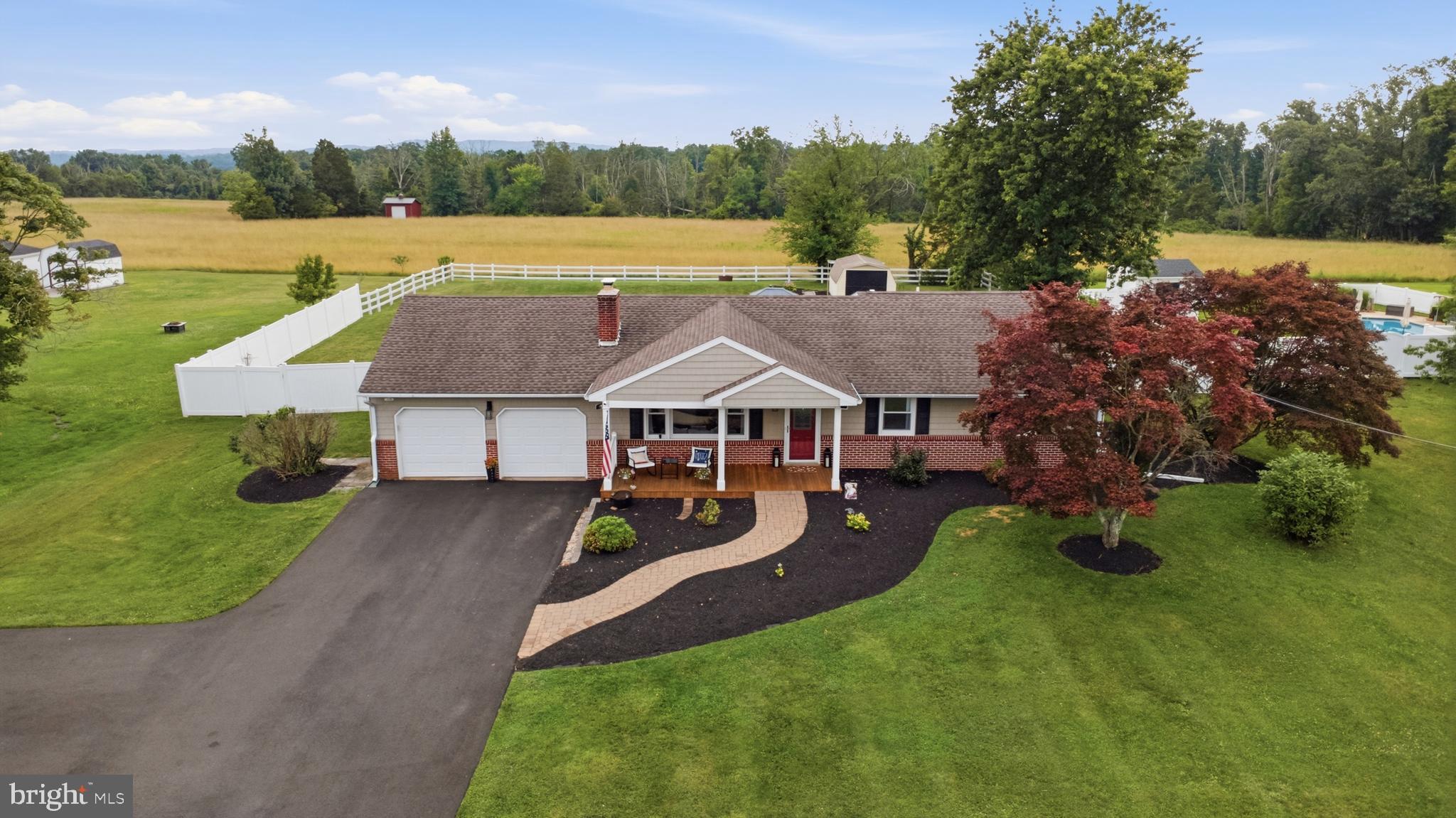 If you've been searching for the perfect ranch home, your wait is over! This beautifully remodeled 3-bedroom, 2-bath home in desirable Upper Salford Township offers the ideal blend of modern updates, thoughtful design, and peaceful country living. A charming paver walkway leads to the inviting covered front porch, complete with rich mahogany flooring and an outdoor ceiling fan. It is the perfect place to relax and enjoy the surrounding views. Step inside to a warm and welcoming living room featuring gleaming hardwood floors, recessed lighting, and a cozy wood-burning fireplace with a classic brick hearth.
The stunning, fully remodeled kitchen is sure to impress with granite countertops, soft-close cabinetry and drawers, pull-out shelving, under-cabinet lighting, built-in outlets, and complete with newer matte stainless-steel appliances. The open-concept layout flows seamlessly into the dining area and continues into a bright and versatile four seasons sunroom that can easily serve as a family room, reading nook, home office, or morning room. Sliding glass doors provide easy access to the rear deck, making indoor-outdoor entertainment a breeze. Down the hallway, you'll find two spacious secondary bedrooms with ample closet space, a beautifully updated hall bath featuring a quartz vanity and tub/shower combination, and a conveniently located laundry area with additional storage cabinetry. The private primary suite is a true retreat, featuring fresh paint and brand-new carpeting, adding a bright, modern touch to this inviting space. The master suite offers direct access to the rear deck, an expansive walk-in closet with a custom organization system, and a luxurious en-suite bath featuring a granite vanity and an impressive 5' x 5' curbless walk-in shower. Designed for both comfort and accessibility, the shower is ADA-compliant and includes built-in seating, shelving, and dual shower heads, creating a spa-like experience in the comfort of your own home. The oversized heated two-car garage includes a utility sink and provides interior access to the finished basement. This expansive lower level offers endless possibilities as a media room, game room, hobby space, home gym, or the ultimate entertaining area. Two additional unfinished storage areas are in the basement too. Situated on a picturesque ¾-acre lot, this property offers scenic views in every direction, with long-distance views from the front and peaceful farmland stretching behind the home. If you enjoy spending time outdoors, you'll love the convenience of having numerous parks, the Perkiomen trail, and Spring Mountain just minutes away! This truly move-in-ready home has been thoughtfully updated from top to bottom and offers the perfect combination of comfort, style, and country charm. Don't miss your opportunity to make this exceptional property your next home!