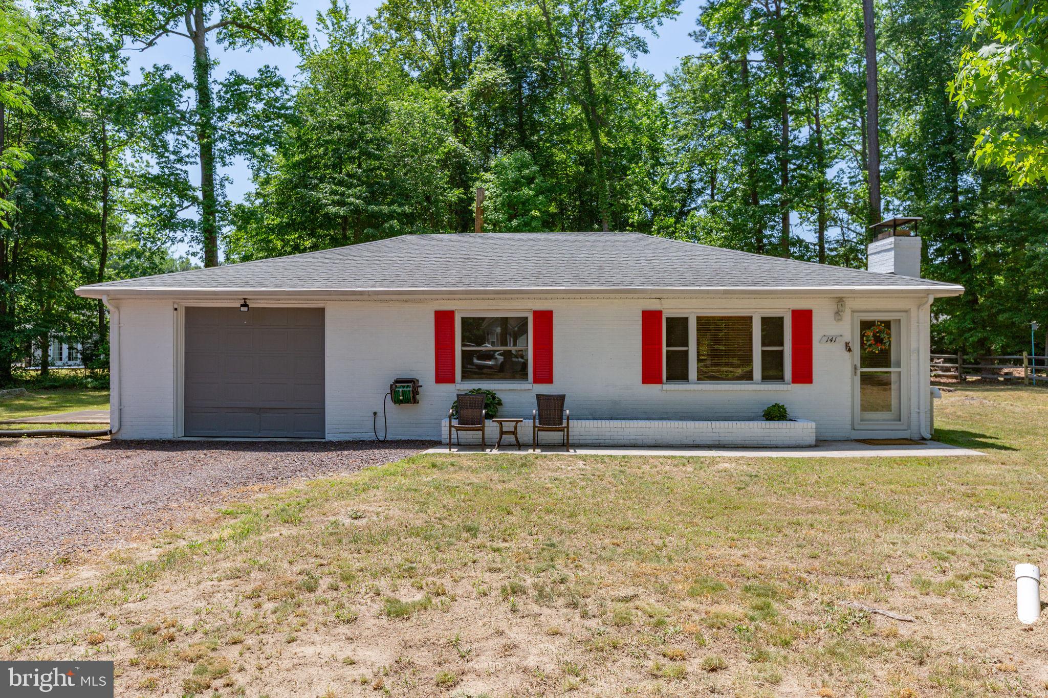 Weekend getaway, full-time residence, or peaceful river-area retreat — this charming Colonial Beach home in Westmoreland Shores offers the space, flexibility, and setting buyers love. Situated on two lots with a large, level yard estimated between .55 and .71 acres, this property gives you room to spread out, garden, entertain, store your boat, or simply enjoy a quieter pace near the water.

Beautifully remodeled in 2018, the home features an architectural shingle roof, updated windows, fresh paint, newer blinds, updated flooring, carpet in the bedrooms, living room, and sunroom, plus refreshed kitchen cabinets, counters, and appliances. The home is exceptionally clean, well cared for, and move-in ready.

The heated sunroom adds comfortable extra living space and includes a woodstove that can help heat the home in an emergency. The main heating system is oil-fired, with the tank neatly housed inside a custom-built wood enclosure. Central air keeps the home comfortable through the warmer months.

Outside, the property really shines. The large, level lot backs to trees, includes a partially wooded setting, and offers a fire pit area ideal for evening gatherings. A 30-foot-long garage provides excellent boat storage, hobby space, or workshop use, complete with plenty of counter and cabinet space.

Located in Westmoreland Shores with easy access to Monroe Bay, this is a terrific opportunity for buyers seeking a clean, updated home near the water with land, storage, privacy, and true Colonial Beach charm.