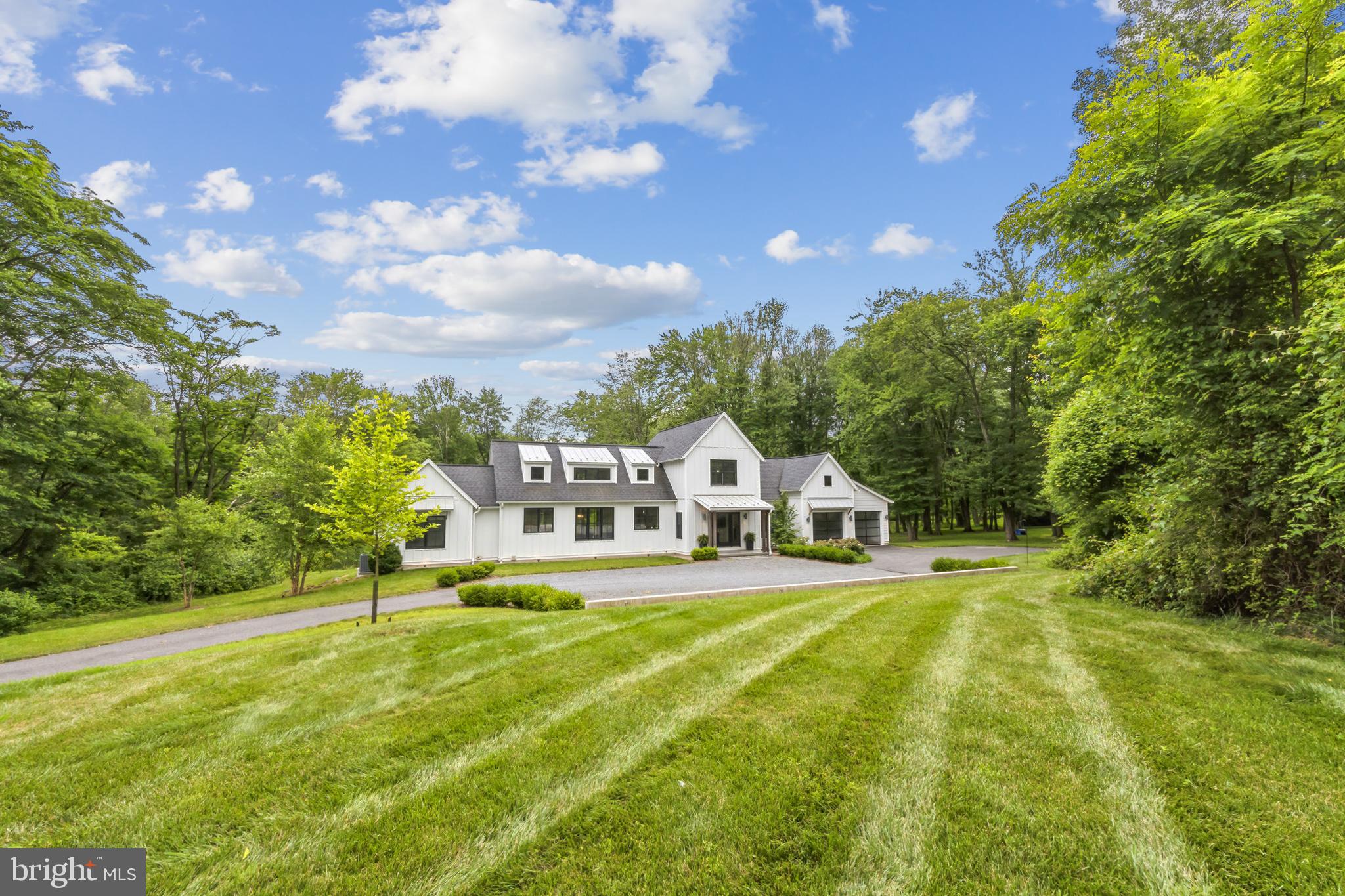 Welcome to 1130 N Middletown Road, an exquisite custom home set on a private 4.5 acre retreat, just minutes from Media Borough. Thoughtfully detailed and exceptionally executed, this property presents a unique opportunity for the discerning homebuyer. Entering the driveway, the home sits tucked back from the road in the center of the property. A modern, clean design aesthetic is reflected in all elements of the home, including the attached garage and guest parking area. Enter the front door into a large foyer, which is currently a music room with grand piano. The interior shutters hearken to the islands and set the tone of relaxation that permeates the property. To the right is an office with a full wall of windows and hardwood floors that run through the home. The center of the house is the open great room, including the kitchen, dining room, living room and a glass wall that opens fully to a wonderful large, screened porch overlooking the pool, spa and patio with gas firepit. By opening the wall, the entire space becomes open air and flows easily from one area to the next, ideal for entertaining. The kitchen features a six burner Thermador gas cook top with large hood, a SubZero refrigerator that is paneled to match the white shaker Kountry Kraft cabinets, two Marvel beverage/wine fridges, a Scotsman ice machine, oversize subway tile backsplash, quartz counters, and a large central island with seating for four. At the other end of the open plan is the living room with gas fireplace with tile surround and a custom TV niche. Between the two is the dining room with ample space for large gatherings. Behind the kitchen, leading to the garage is the laundry room, storage closets and bar area, conveniently placed near a door to the pool and patio. The indoor and outdoor spaces are seamlessly integrated and connected, both visually and physically. Off to the side of the great room is a bedroom wing – at one end is a bedroom and hall bath. At the other end is the primary suite allowing for true one-floor living. This suite has a walk-in dressing room with built-ins so that no clothing storage is needed in the primary bedroom. The primary bathroom offers a walk-in shower, WC, ample space for two and excellent storage. The view from the bedroom itself is fantastic, with French doors overlooking and accessing the pool, spa and patio, reinforcing the indoor/outdoor lifestyle. Upstairs are two additional bedrooms that share a full hall bath. Downstairs is a full, unfinished walkout basement offering storage, workout areas, utility room, and unlimited potential.  The outdoor living areas are set at grade with the primary floor of the home, designed to overlook acres of lawn, meadows, woodlands, rain garden and a tiny stream in the distance. The flora and the fauna of the property are truly breathtaking. Located only 10 minutes from the heart of Media Borough; and 20 minutes from downtown West Chester, within the highly rated Rose Tree Media School District; and convenient to public transit, the airport and Philadelphia, 1130 N Middletown offers a relaxing peaceful “getaway” without ever leaving your home and all that our region offers.