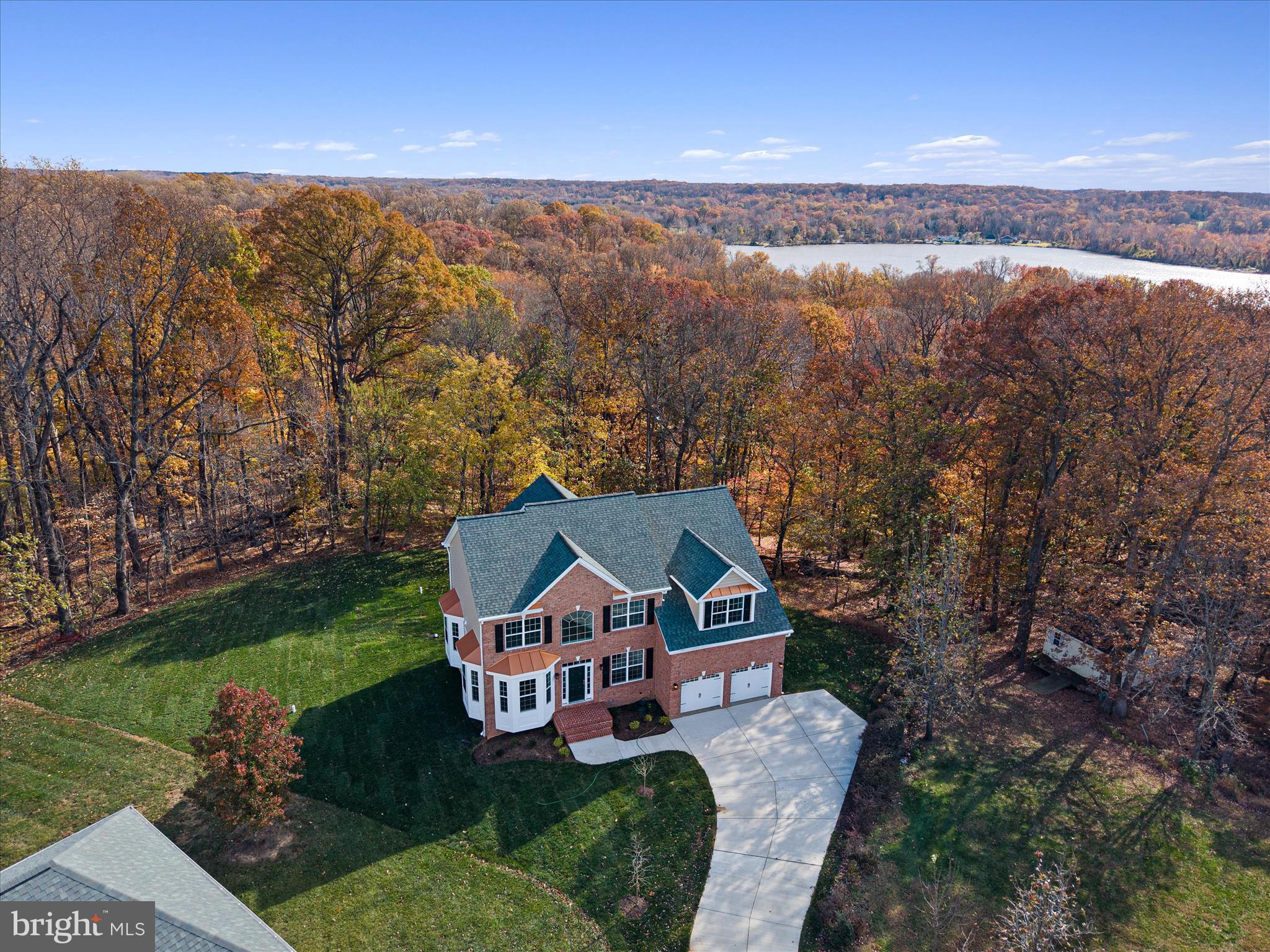 JUST REDUCED!!!!Nestled in the serene WATERFORD COVE community, this stunning new construction home, completed in 2025, offers a perfect blend of modern elegance and comfort. The Colonial architectural style, featuring a charming brick front and vinyl siding, invites you into a warm and inviting space. Step inside to discover a thoughtfully designed interior with five spacious bedrooms and three and a half bathrooms. The heart of the home is the expansive kitchen, equipped with stainless steel appliances, including a built-in range and wall oven, complemented by upgraded countertops and a generous island—ideal for both casual meals and entertaining. The family room, conveniently located off the kitchen, features a cozy gas fireplace, creating a perfect gathering spot. Natural light floods the home through double-pane windows, enhancing the beauty of the hardwood and marble flooring. The primary suite boasts a luxurious bathroom with a soaking tub and walk-in shower, providing a private retreat. Additional features include a formal dining room, a breakfast area, and recessed lighting throughout. Set on a sprawling 2.55-acre lot, this property backs to parkland and trees, offering scenic vistas and a peaceful atmosphere. Enjoy outdoor living on the spacious deck, perfect for relaxation or entertaining. The home also includes a fully finished, heated basement with a walkout entrance, providing endless possibilities for recreation or storage. Conveniently located adjoining a national park, this home offers tranquility while being just a short drive from local amenities. With an attached garage and ample driveway space, parking is a breeze. Fabulous deck overlooking rear yard. Experience the perfect blend of luxury and nature in this exceptional residence. Look at Documents for a flyer detailing a finance program.