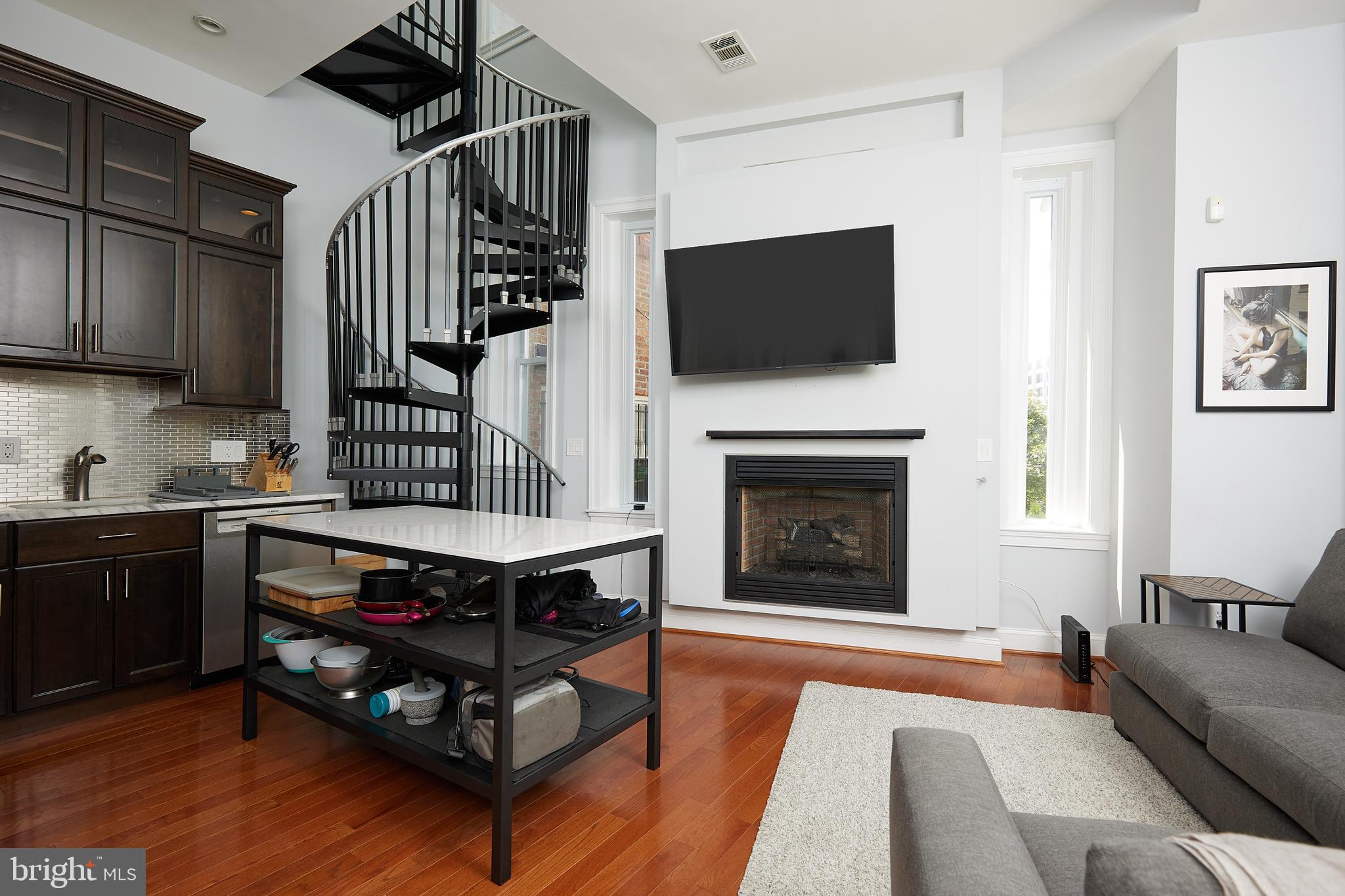 Live in desirable Kalorama in a loft-style condo located in a boutique 4-unit building. This spacious 1 bedroom 1.5 bathroom condo offers soaring ceilings, an open layout thats flooded with natural light. Features hardwood floors, gas fireplace, updated kitchen with gas cooking, stainless steel appliances, and a half bath on main level. The spiral staircase leads to a spacious bedroom suite, with a large walk-in closet, in unit full size washer/dryer and ensuite bathroom. Steps to the Dupont Circle Metro, Kalorama park, grocery stores, dining, shops, and all that Kalorama has to offer.
