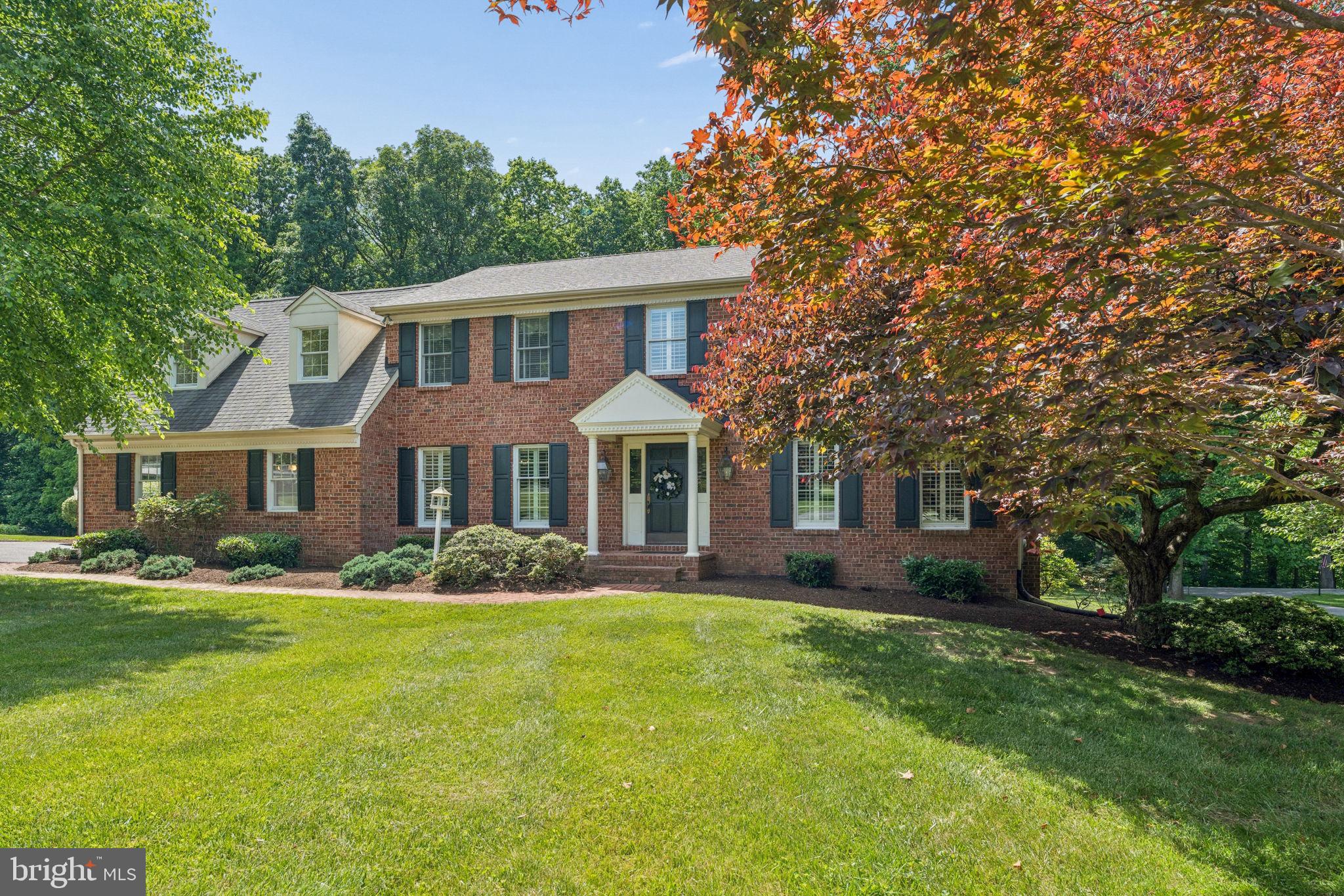 This Stately Brick Colonial with 4-bedrooms & 2.5 updated baths sits at the end of a private panhandle drive on a level 2.16-acre lot, offering privacy with access to the Jacksonville/4 Corners area.
Inside, there are 2 levels of hardwood floors and classic moldings. Formal living and family rooms each feature beautifully refurbished & re-lined fireplaces. The formal dining room opens to an updated chef’s kitchen with granite countertops, stainless steel appliances, and a bright breakfast area.  The Trex deck, a freshly stained sunporch and a brick patio below extend your summer living.

Upstairs, the primary suite has gleaming hardwood floors, refined moldings, an updated spa bath (2018), and a custom, walk-in California Closet (2025). Through the attached French Doors is a lovely and light-filled room w/hardwood floors, that would be ideal as a work from home office, den or nursery.  It also includes built-ins and elevator access to the main level near the mudroom.  The upper-level hallway, detailed with beautiful millwork, connects 3 additional bedrooms with hardwood floors & natural light.  These rooms share an updated hall bath with quartz finishes (2018) and a tub/shower combination, with a newly installed shower diverter.  (2026)

The walkout lower level has a nice recreation room with a pool table & 2 newly installed electric heaters.  The recently painted utility room has a new hot water heater (installed 3/26). Outside, the deck, sunporch, and brick patio back to private woodlands.  The  attached, 2 car, side load garage is freshly painted w/a granite/epoxy floor and a new laundry tub.

Experience timeless craftsmanship, in  a home that is impeccably maintained, and in a serene setting—which hopefully will provide peace of mind for the new buyer(s).  Schedule your private showing today! 
( Information w additional updates will be provided on a separate form).