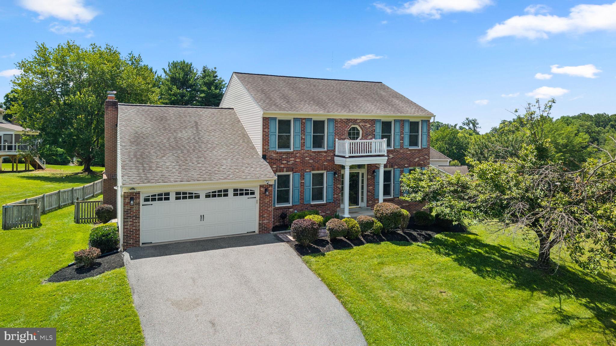 Beautifully maintained Colonial residence offering 4 bedrooms, 3 full bathrooms, 1 half bathroom, 3,284 finished square feet, and a 2-car garage in desirable Worthington Park.  A welcoming foyer with luxury vinyl tile flooring and a convenient powder room introduces the traditional floor plan. To the right, the formal living room flows seamlessly into the formal dining room, where laminate flooring, elegant lower wainscoting, and rich dark accent walls create sophisticated spaces for entertaining.  The spacious eat-in kitchen is thoughtfully designed with a center island and breakfast bar, white cabinetry, ample countertop space, a custom tile backsplash, sleek black and stainless steel appliances, a pantry, and a built-in writing station. Adjacent to the kitchen, the cozy breakfast room is highlighted by a statement chandelier, bay windows, and convenient access to the laundry room.  Just a step down from the breakfast area, the impressive family room serves as the heart of the home, featuring soaring cathedral ceilings with skylights, charming arched windows, laminate flooring, and a brick wood-burning fireplace. Double sliding glass doors provide seamless access to the deck, creating an ideal setting for indoor-outdoor living and entertaining.  The upper level offers four generously sized bedrooms, all featuring luxury vinyl tile flooring. The spacious owner's suite is enhanced by vaulted ceilings, a walk-in closet, and a private ensuite bath with a dual-sink vanity, corner soaking tub, and separate shower. A second full bathroom serves the remaining bedrooms.  The finished lower level provides exceptional flexibility with a spacious recreation room featuring under-stair storage, a dedicated theater/media room, and a versatile bonus room with an attached full bathroom—ideal for guests, a home office, or hobby space. A separate storage room provides additional organizational space.  Step outside to enjoy the expansive deck overlooking the fully fenced backyard, complete with a private sport court that offers endless opportunities for recreation, entertaining, and outdoor fun.