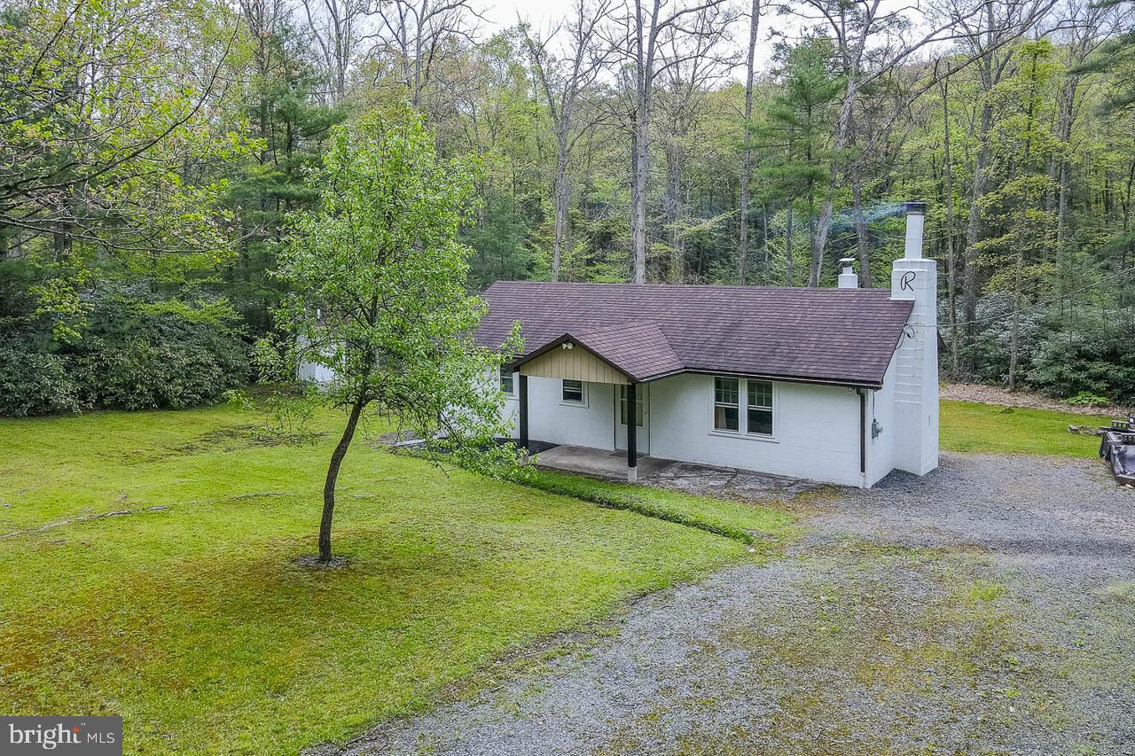 Tucked away in the heart of Rothrock State Forest, this beautifully remodeled 2-bedroom camp is the perfect getaway for nature lovers seeking peace, privacy, and outdoor adventure.  Offering approximately 800 square feet of thoughtfully updated living space.  Enjoy cozy evenings by the fireplace, while air conditioning keeps the camp comfortable during warmer months.  Ideally located just a short drive from Penn State University, Colyer Lake, Bear Meadows, and Tussey Mountain, this property offers convenient access to hiking, biking, skiing, fishing, Penn State events, and endless outdoor recreation.  A rare opportunity to own a move-in ready mountain escape in a truly beautiful setting.  Potential buyers should be sure to review DCNR lease requirements and documents.